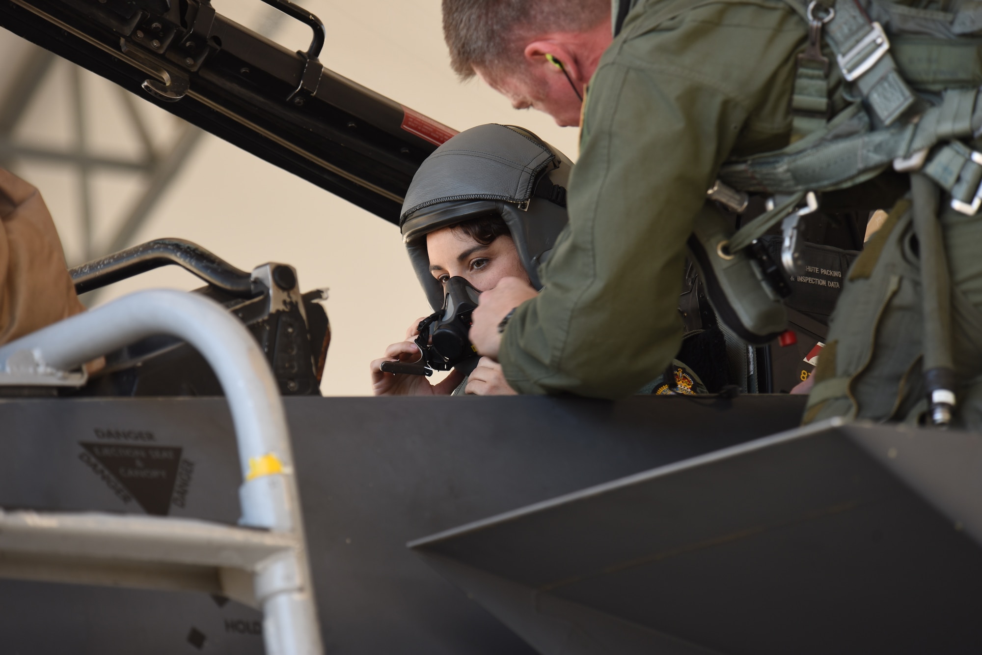 Lt. Col. Jason Taylor, 334th Fighter Squadron commander, prepares singer song-writer Danika Portz for an incentive in an F-15E Strike Eagle, May 17, 2017, at Seymour Johnson Air Force Base, North Carolina. This year’s Wings Over Wayne Air Show features 21 ground and aerial acts and an opening performance by Portz who will sing the National Anthem. (U.S. Air Force photo by Airman 1st Class Miranda A. Loera)