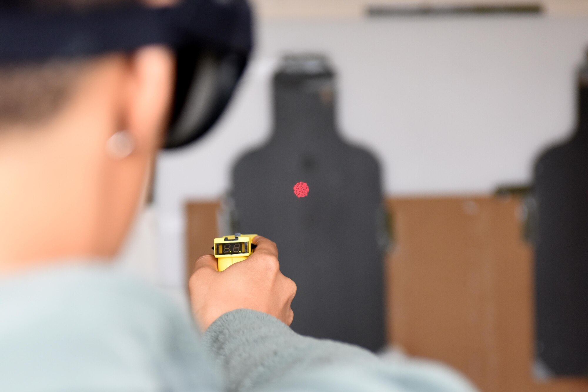 An Airman assigned to the 48th Fighter Wing shoots a taser during an event for National Police Week at Royal Air Force Lakenheath, England, May 19. During the event, Airmen from all around base were given the opportunity to see what it is like to be a defender. (U.S. Air Force photo/Airman 1st Class Eli Chevalier)