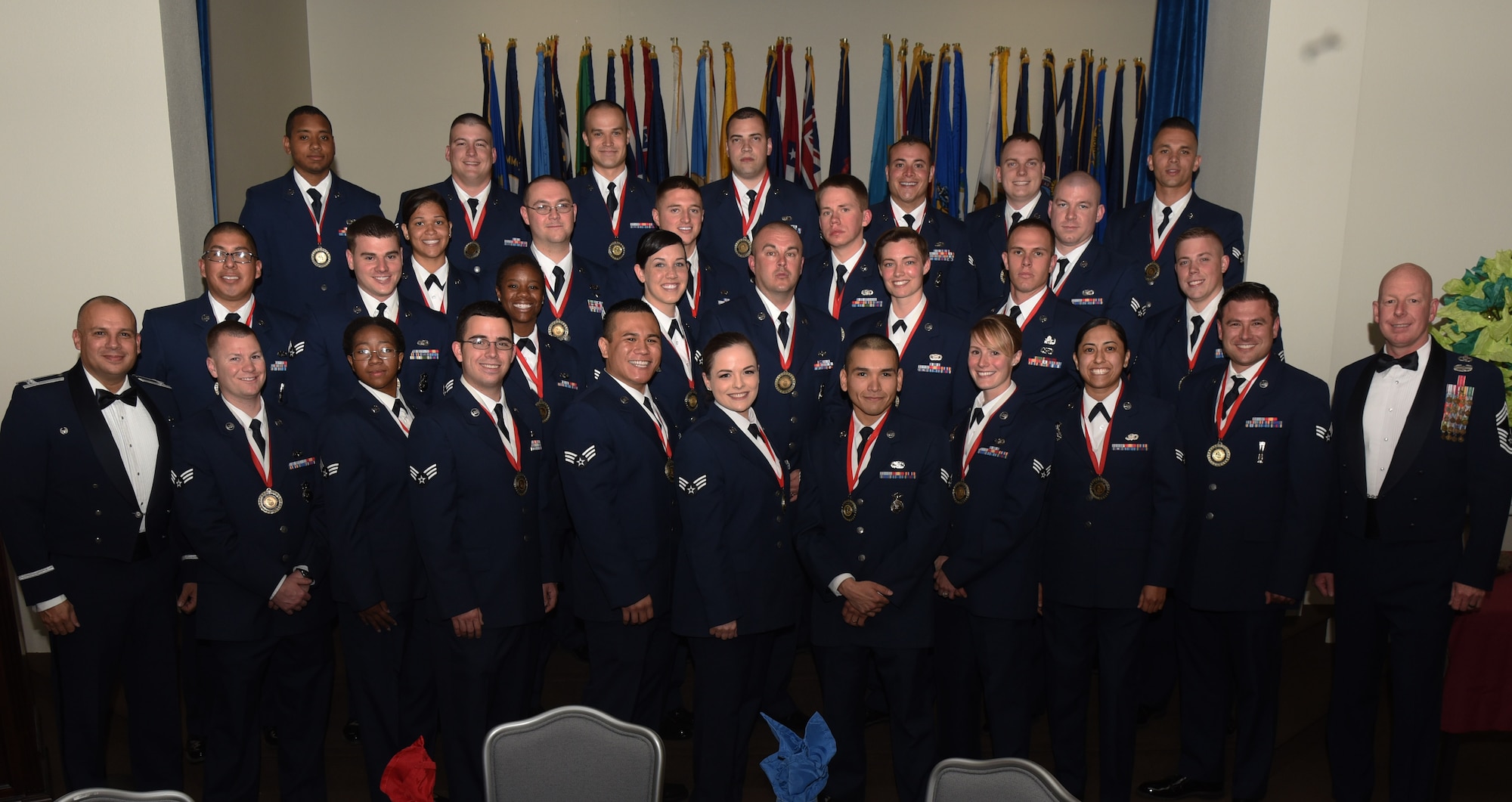 Col. Frank Verdugo, 90th Mission Support Group commander and Chief Master Sgt. Christopher Pollock, 90th Mission Support Group superintendent, poses with the graduating Airman Leadership School Class 17-E students at F.E. Warren Air Force Base, Wyo., May 17, 2017. Enlisted Airmen must complete the rigorous professional military education course to become supervisors of other Airmen. (U.S. Air Force photo by Airman 1st Class Breanna Carter)