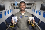2nd Lt. Rodrigo Vener, 359the Aerospace Medicine Squadron Aerospace and Operational Physiology Training Unit physiologist, holds photos of himself and his father inside the altitude chamber May 15, 2017, at Joint Base San Antonio-Randolph, Texas.  Vener credits his father for encouraging him to join the U.S. Air Force.