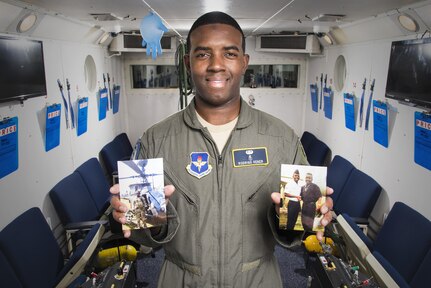 2nd Lt. Rodrigo Vener, 359the Aerospace Medicine Squadron Aerospace and Operational Physiology Training Unit physiologist, holds photos of himself and his father inside the altitude chamber May 15, 2017, at Joint Base San Antonio-Randolph, Texas.  Vener credits his father for encouraging him to join the U.S. Air Force.
