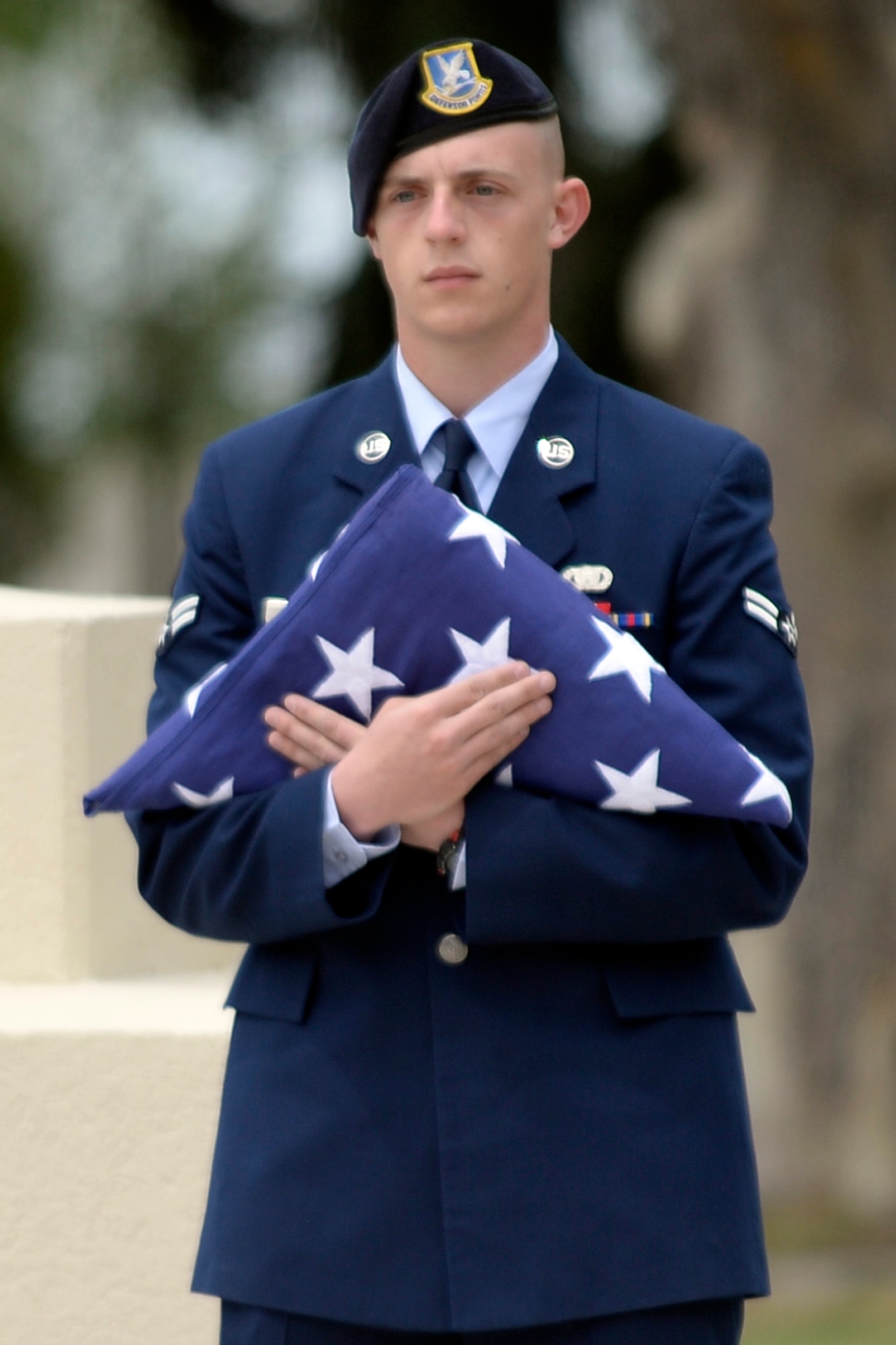 Airman 1st Class Hunter Nelson, 75th Security Forces Squadron, holds a folded U.S. flag in preparation for a retreat ceremony May 18 at Hill Air Force Base. Nelson, other 75th SFS members, Airmen and civilians honored fallen law enforcement officers as part of National Police Week activities. (U.S. Air Force/Todd Cromar)