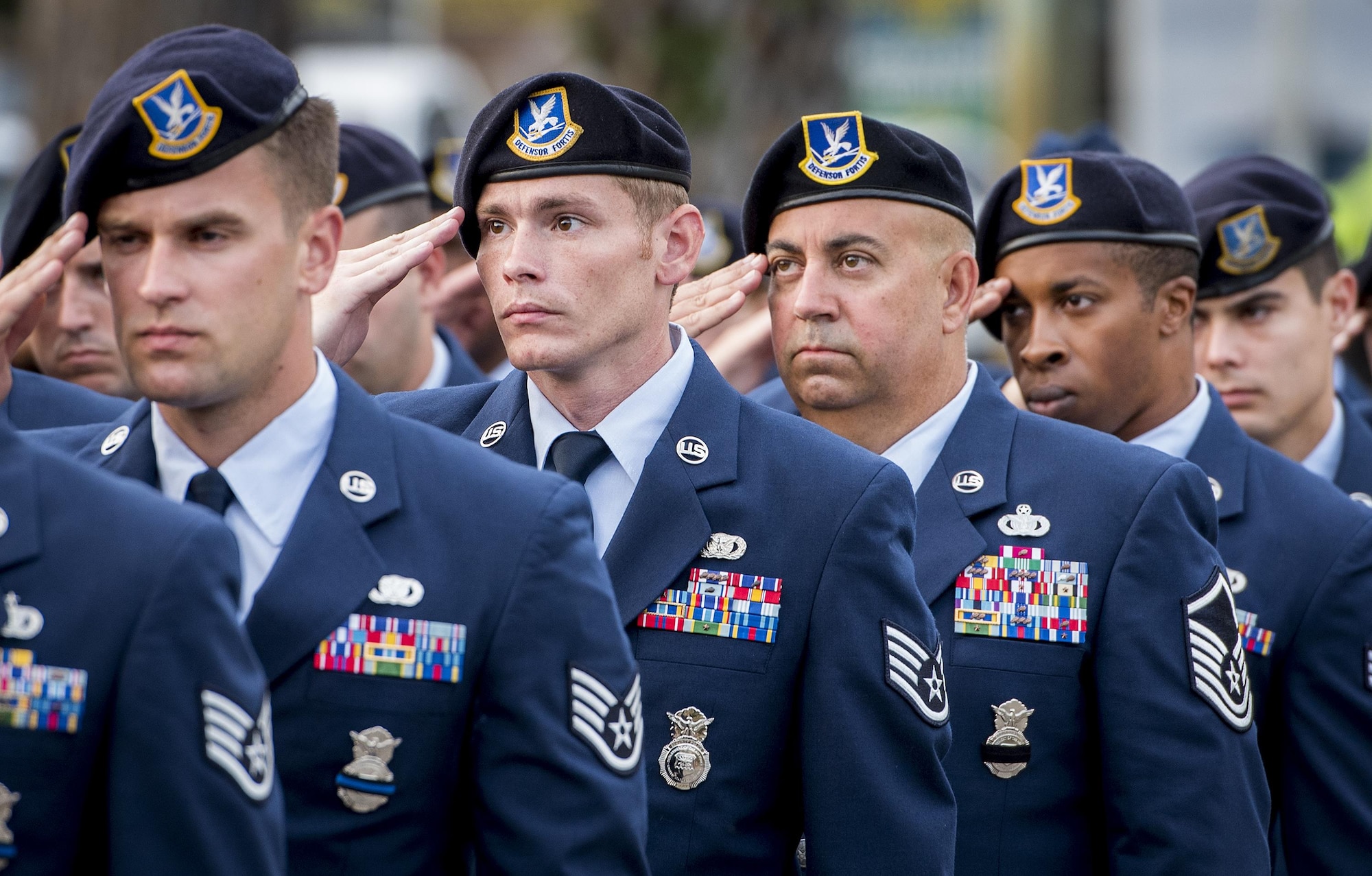 A formation of Air Force Security Forces Airmen salutes during the posting of the colors at the Peace Officers’ Memorial Ceremony May 18 in Fort Walton Beach, Fla. The ceremony was to honor fallen police officers from the previous year by reading their names aloud. Security forces Airmen from Eglin and Hurlburt Field attended and participated in the event. The ceremony is one of many events taking place during National Police Week. (U.S. Air Force photo/Samuel King Jr.)