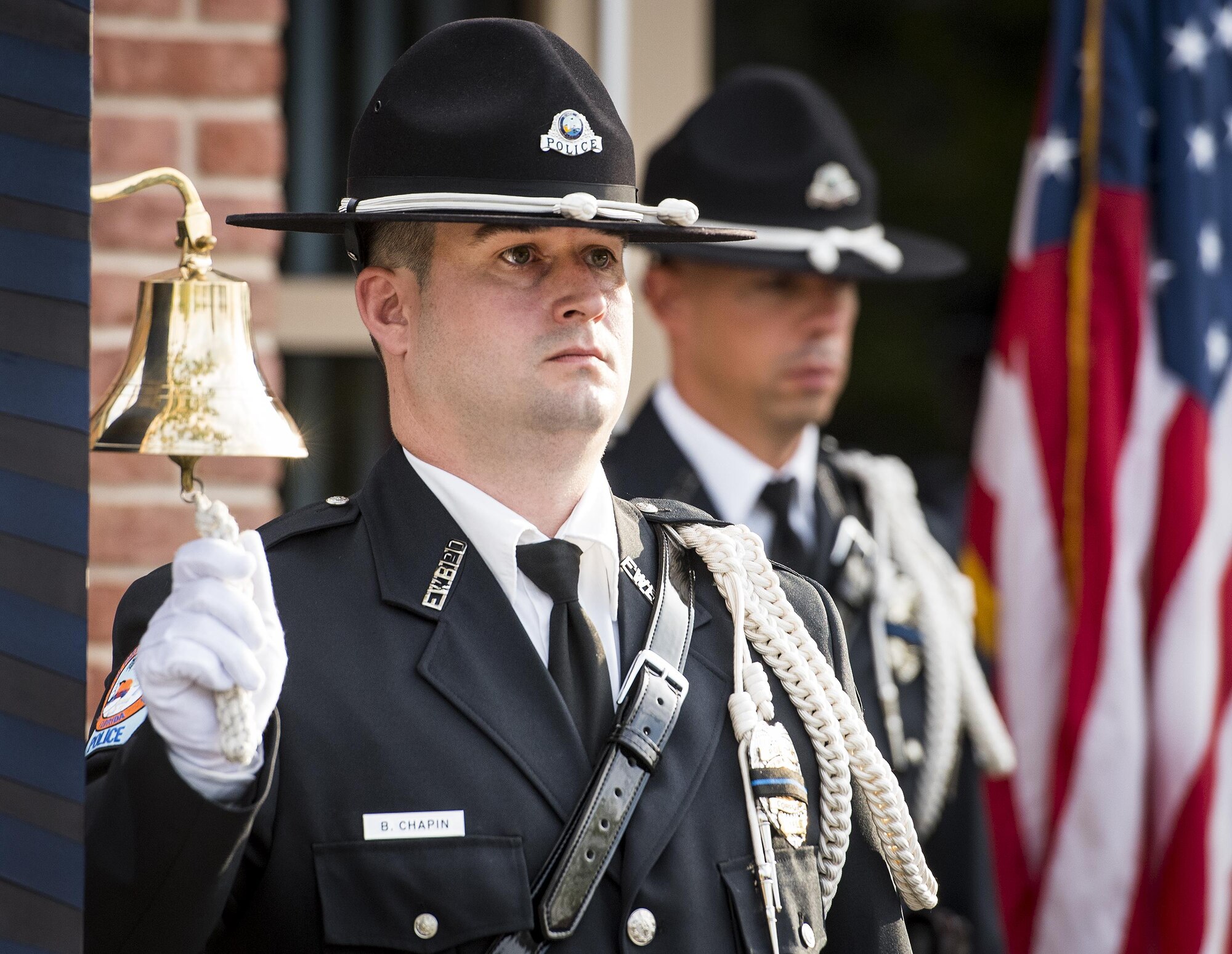 Fort Walton Beach Police Officer Chapin rings a bell as each name of fallen local police officers are called out at the Peace Officers’ Memorial Ceremony May 18 in Fort Walton Beach, Fla. The ceremony was to honor fallen police officers from the previous year by reading their names aloud. Security forces Airmen from Eglin and Hurlburt Field attended and participated in the event. The ceremony is one of many events taking place during National Police Week. (U.S. Air Force photo/Samuel King Jr.)