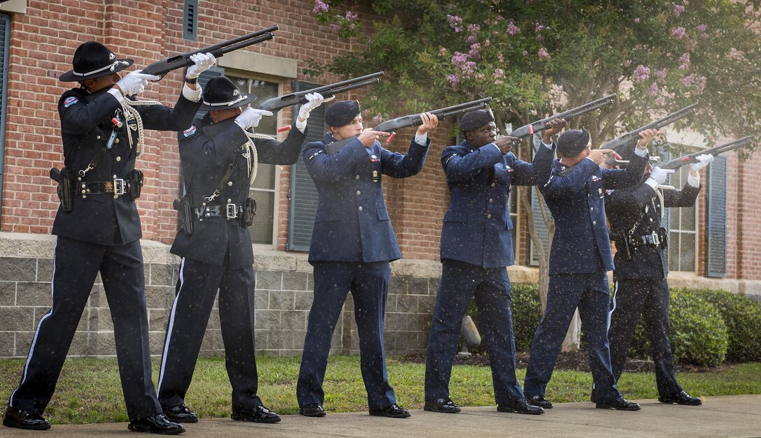 Shells fly from the weapons used by Fort Walton Beach Police Department color guard and 1st Special Operations Security Forces Squadron Airmen during a shotgun volley salute at the Peace Officers’ Memorial Ceremony May 18 in Fort Walton Beach, Fla. The ceremony was to honor fallen police officers from the previous year by reading their names aloud. Security forces Airmen from Eglin and Hurlburt Field attended and participated in the event. The ceremony is one of many events taking place during National Police Week. (U.S. Air Force photo/Samuel King Jr.)