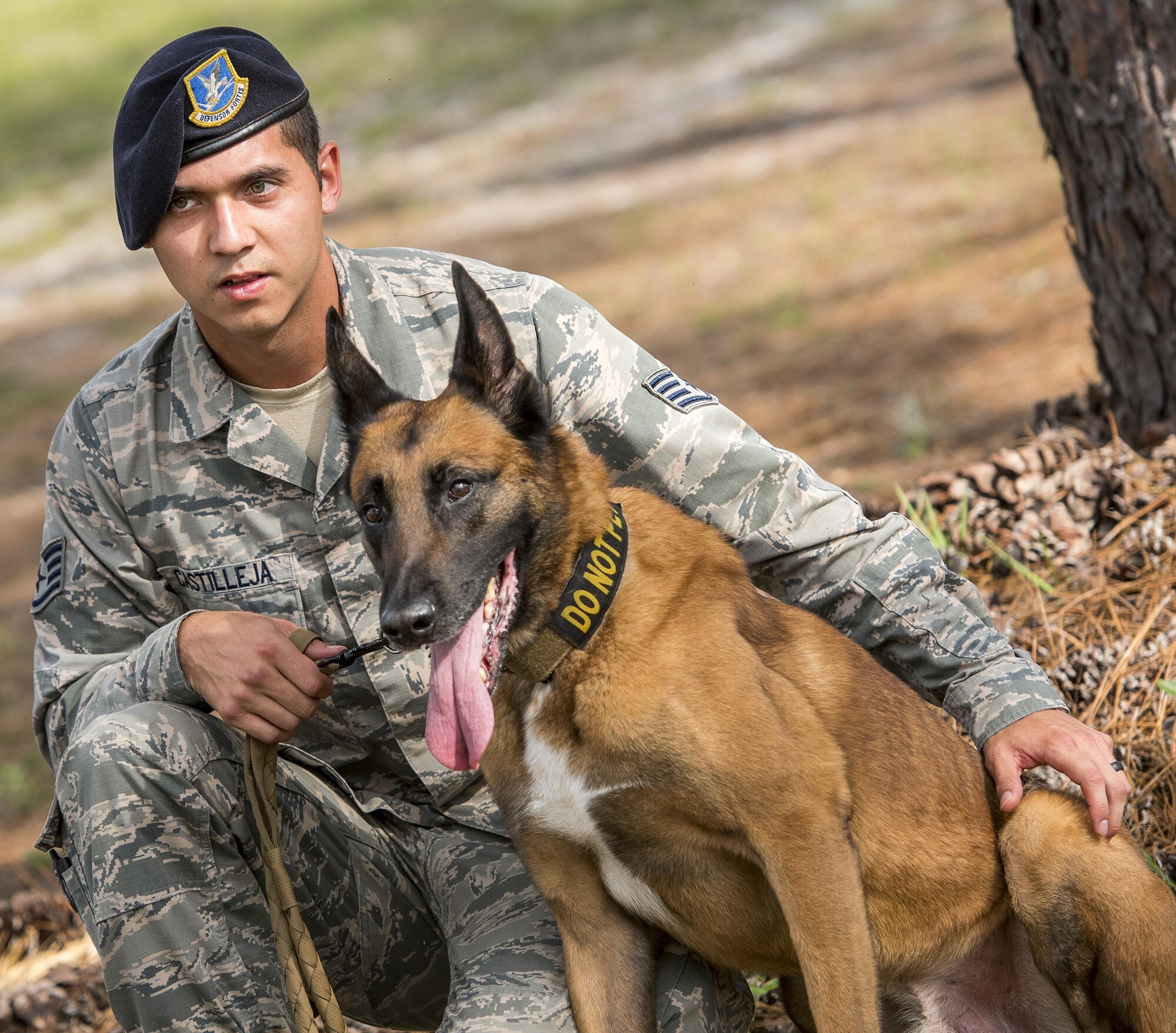 Staff Sgt. Michael Castilleja and Arko, 96th Security Forces Squadron, sit together after a military working dog demonstration for Eglin Elementary School kids May 18 at Eglin Air Force Base, Fla. The event was in celebration of National Police Week. More than 100 children watched the demonstration. (U.S. Air Force photo/Samuel King Jr.)
