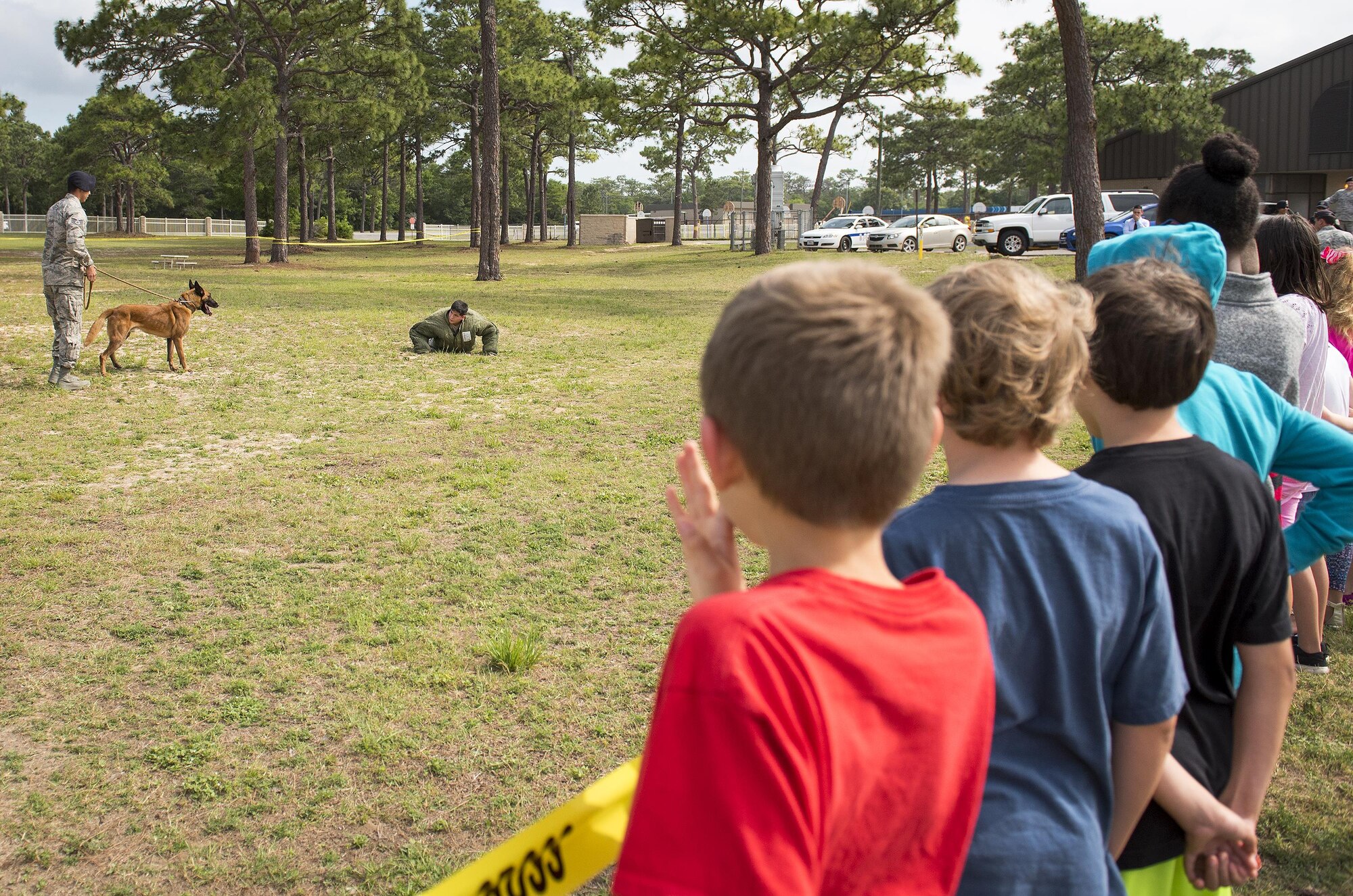Eglin Elementary School students watch a 96th Security Forces Squadron Military Working Dog demonstration May 18 at Eglin Air Force Base, Fla. The event was in celebration of National Police Week. More than 100 children watched the demonstration. (U.S. Air Force photo/Samuel King Jr.)