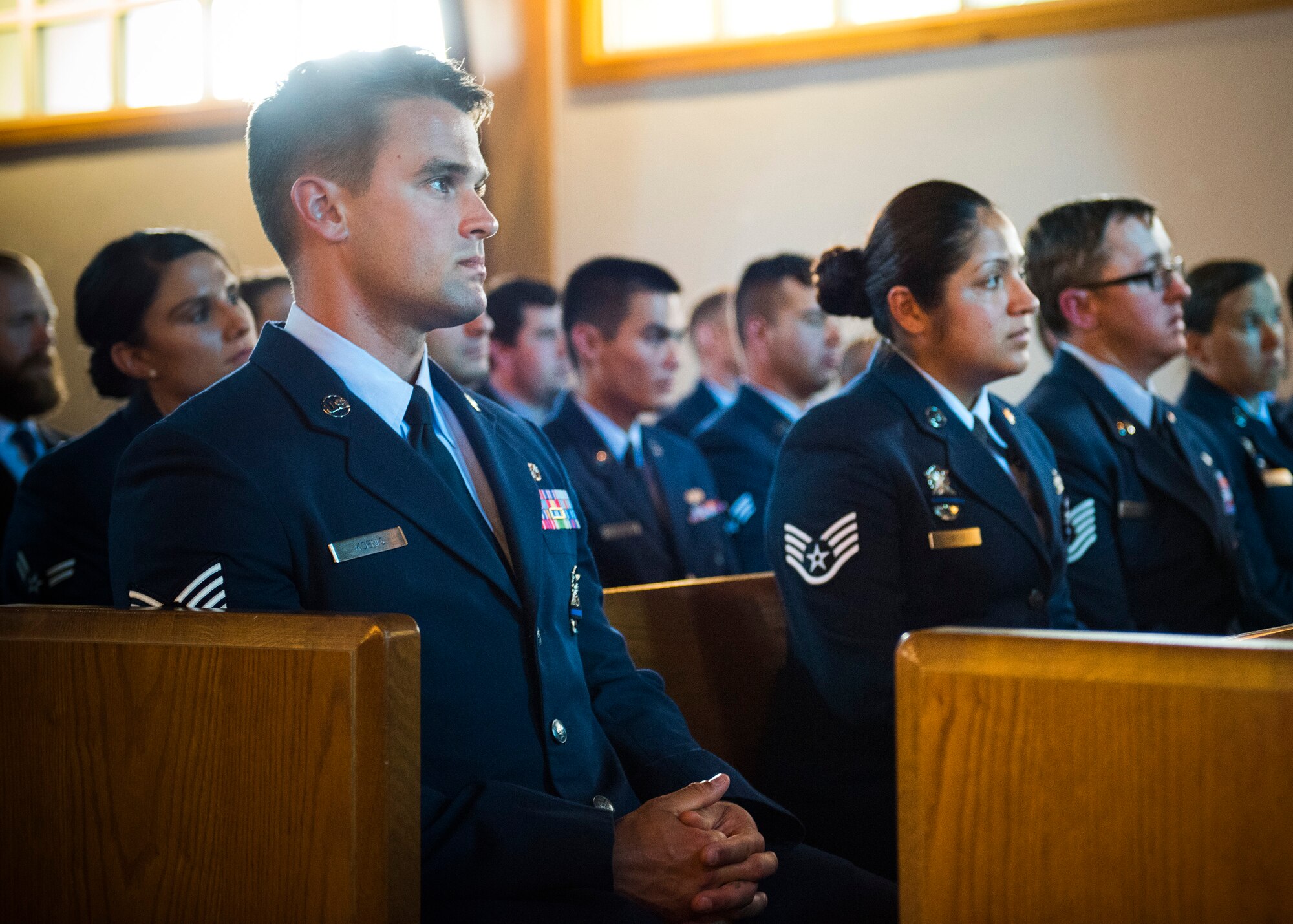 96th Security Forces Squadron Airmen listen to their guest speaker during the National Police Week candlelight vigil May 18 at Eglin Air Force Base, Fla. The ceremony was held to honor the police, defenders and the agents who paid the ultimate sacrifice in the line of duty. To remember them, 14 candles were lit. (U.S. Air Force photo/Ilka Cole)