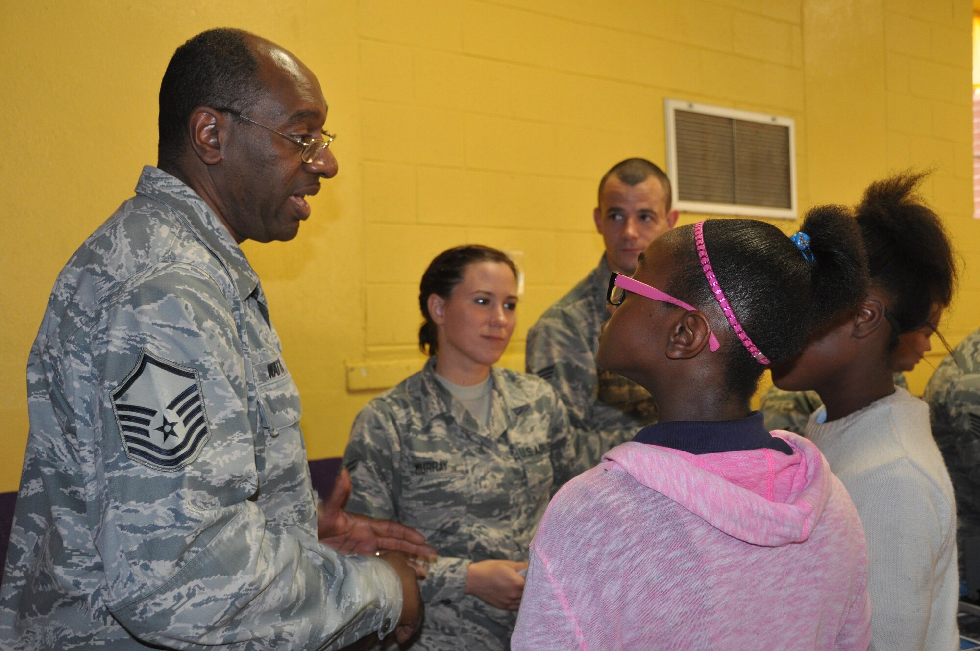 Master Sgt. Melvin Watts, outreach chairman for the Human Resources Development Council for the 908th Airlift Wing, talks to two students May 11. Nine members of the 908th Airlift Wing participated in a career day hosted by Highland Avenue Elementary School in Montgomery, Ala., for fourth and fifth grade students. (U.S. Air Force photo by Bradley J. Clark)