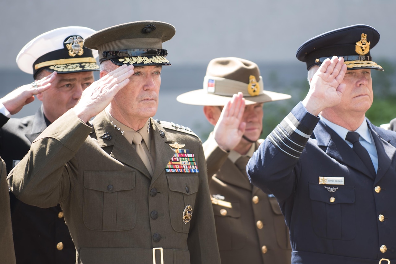 Marine Corps Gen. Joe Dunford, chairman of the Joint Chiefs of Staff, renders honors during a wreath laying ceremony outside NATO Headquarters in Brussels during the Military Committee Meeting, May 17, 2017. The ceremony honored the men and women who have fallen in NATO service. The chiefs of defense met to discuss Afghanistan, countering terrorism and other NATO operations and missions to provide the North Atlantic Council with consensus-based military advice on how to best meet global security challenges. DoD photo by Army Sgt. James K. McCann