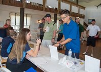 Participants register at the 2017 spring Bluesuiters Golf Tournament May 17, 2017, 2016, at the Jonathan’s Landing Golf Course in Magnolia, Delaware. The biannual tournaments offer Team Dover Airmen a chance to win various prizes and connect with local civic and business leaders. (U.S. Air Force photo by Mauricio Campino)