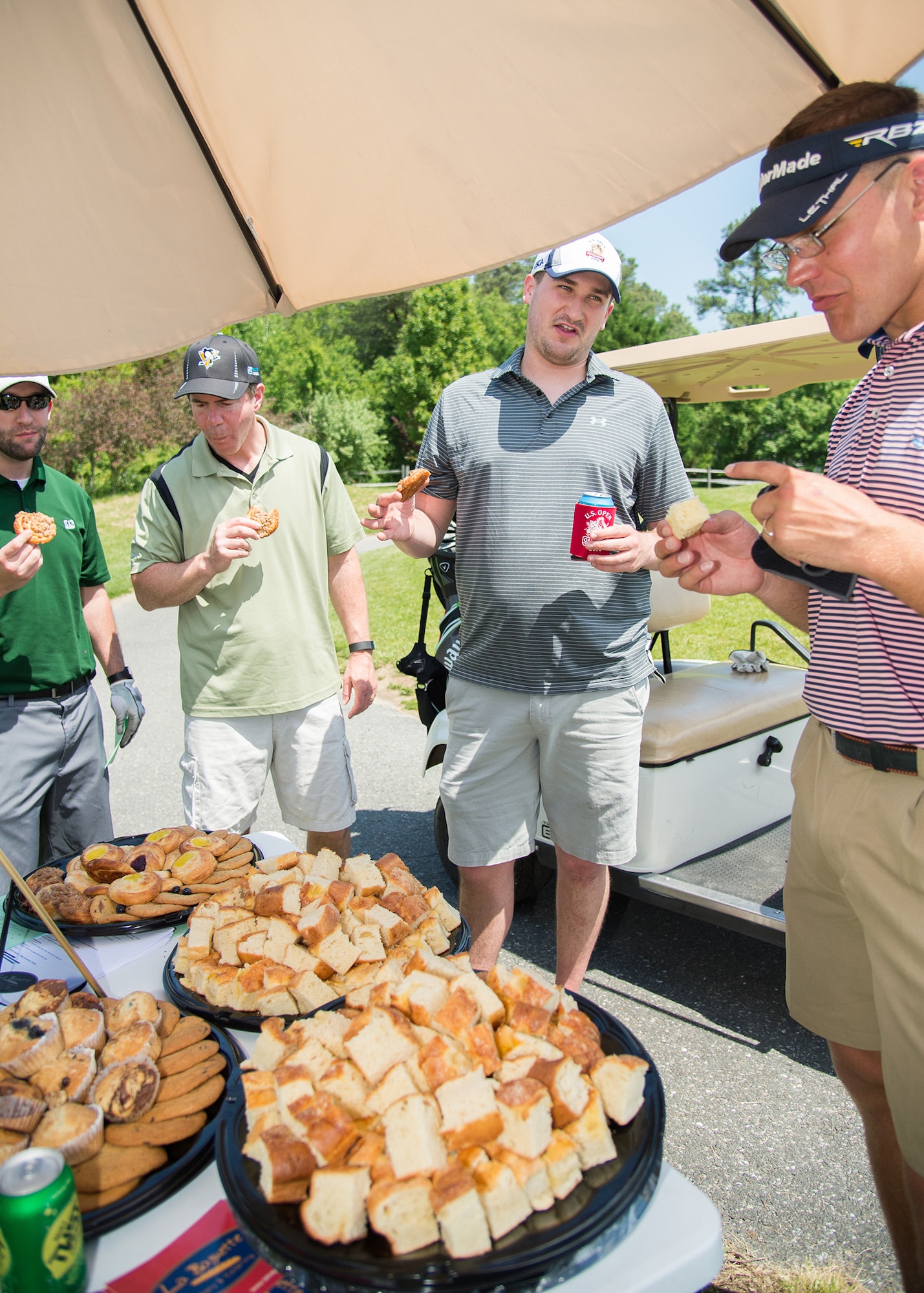 Participants of the 2017 spring Bluesuiters Golf Tournament take a break and enjoy some snacks from La Baguette Bakery May 17, 2017, 2016, at the Jonathan’s Landing Golf Course in Magnolia, Delaware. Four different local businesses set up break stations throughout the 18 hole course. (U.S. Air Force photo by Mauricio Campino)