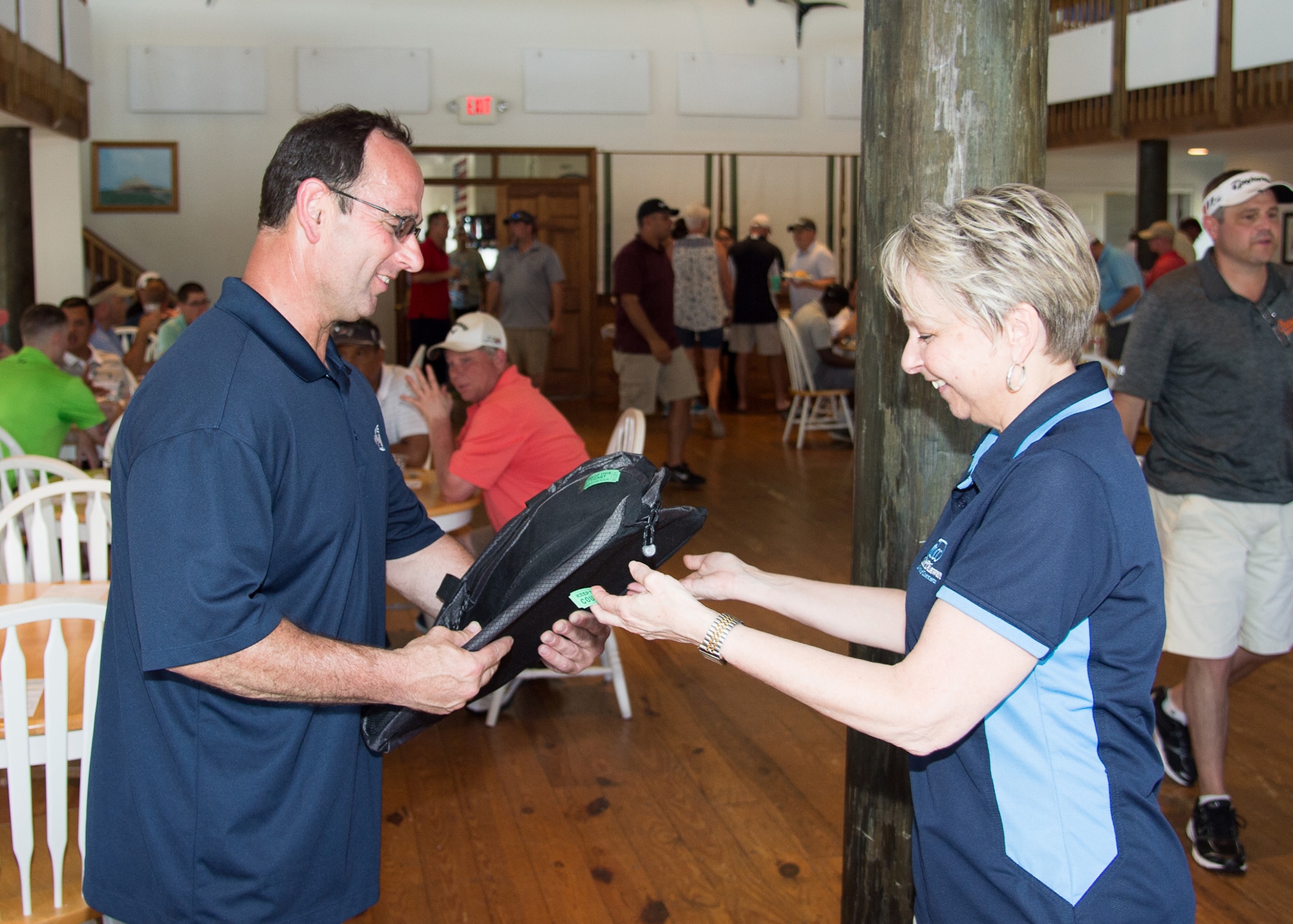 Judy Diogo, President of the Central Delaware Chamber of Commerce hands door prizes to participants at the 2017 spring Bluesuiters Golf Tournament May 17, 2017, 2016, at the Jonathan’s Landing Golf Course in Magnolia, Delaware. The CDCC in cooperation with Dover Air Force Base and several local businesses, sponsor biannual golf tournament aimed at maintaining good community relations. (U.S. Air Force photo by Mauricio Campino)