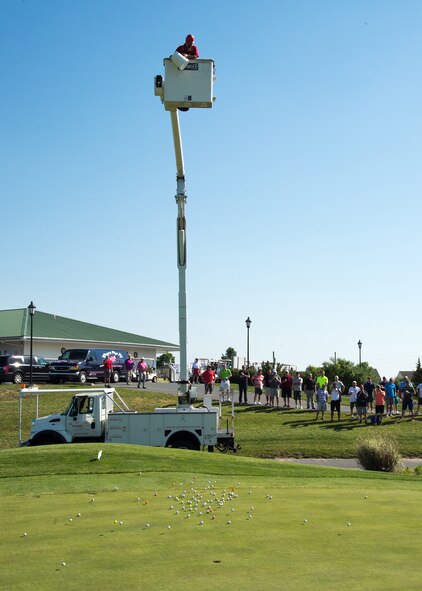 Golfers watch as balls are dropped from a maintenance vehicle at the 2017 spring Bluesuiters Golf Tournament May 17, 2017, 2016, at the Jonathan’s Landing Golf Course in Magnolia, Delaware. Participants were able to purchase the numbered balls beforehand and the owner of the ball closest to the golf hole was awarded a cash prize. The truck was provided by ShureLine Electrical, one of the tournament sponsors. (U.S. Air Force photo by Mauricio Campino)