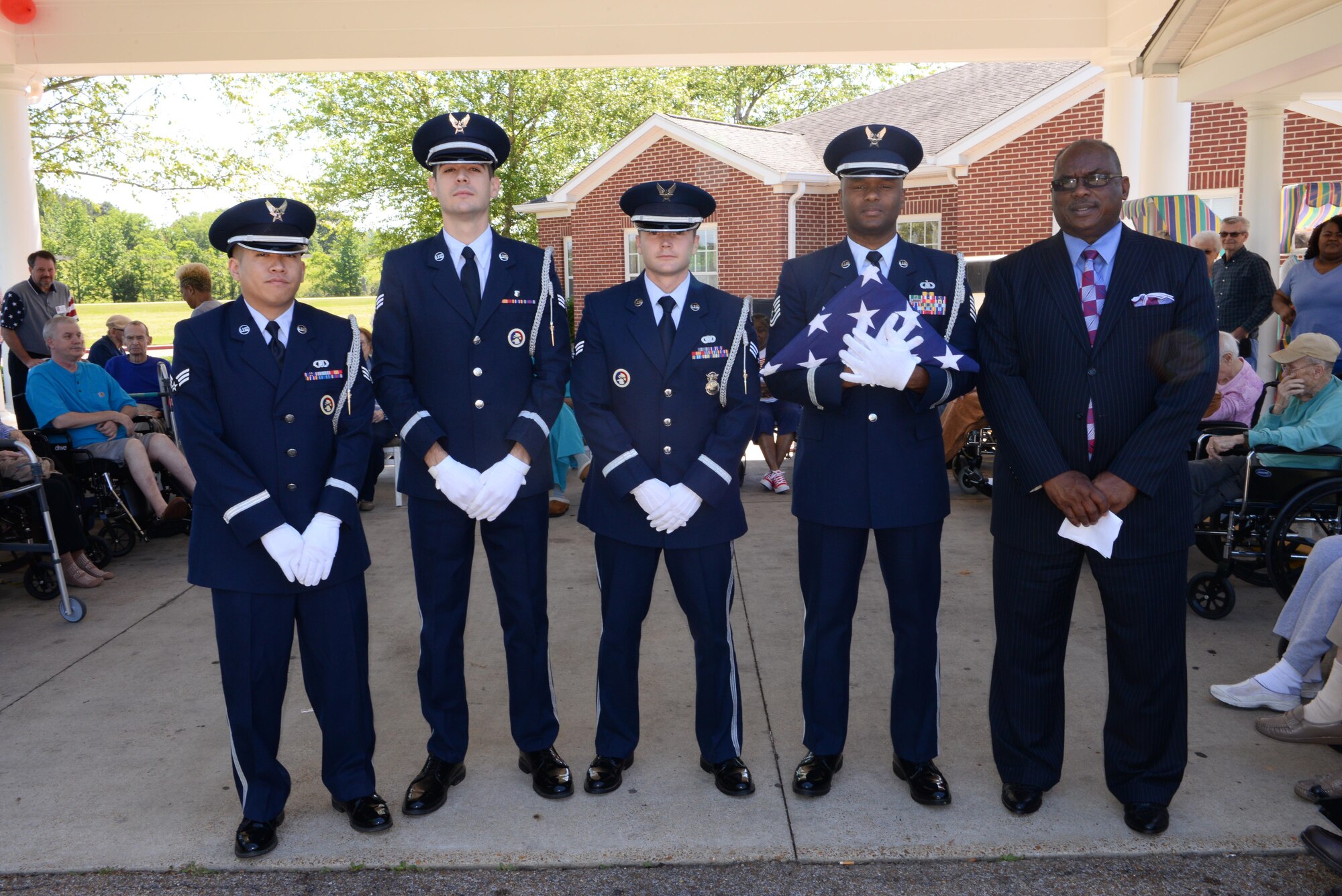 Senior Airman Jeremiah Necaise, Senior Airman Johnathan Rosales, Airman 1st Class Camren Smith, Tech. Sgt. Damon Snead, Columbus Air Force Base Honor Guard members and The Honorable Robert Smith, Mayor of Columbus and Columbus AFB Wingman, pose for a photo May 15, 2017, at the Windsor Retirement home in Columbus, Mississippi. The Honor Guard performed a flag folding ceremony for the retirees to witness. (U.S. Air Force photo by 2nd Lt. Savannah Stephens)