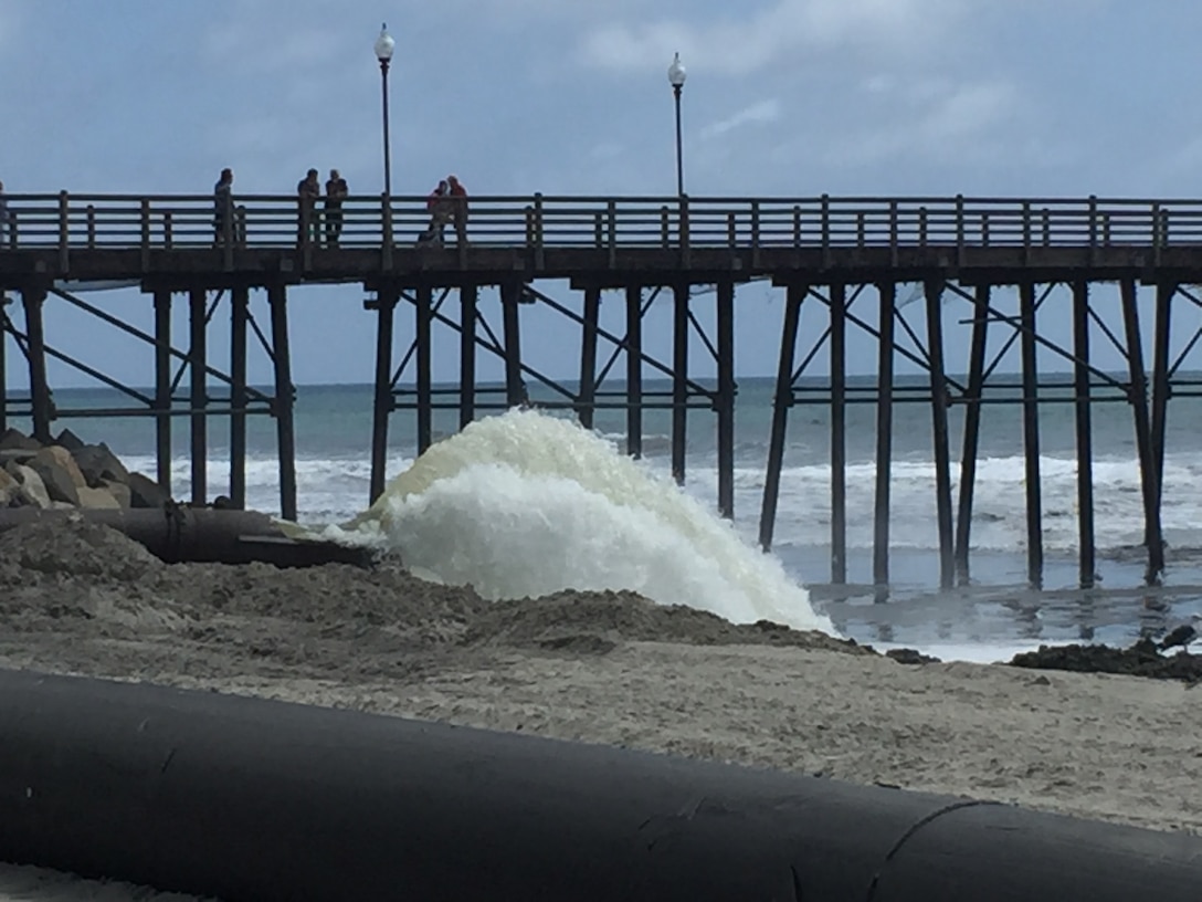Manson Construction Company, the contractor for the Oceanside Harbor channel annual maintenance project, flushes the discharge line in preparation of extending the pipe farther south along the beach.