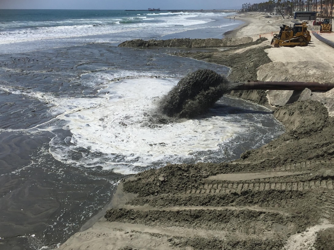 Material from the Oceanside Harbor channel annual maintenance project is discharged adjacent to the Oceanside Pier. The material will increase the beach width, enhancing recreation opportunities and increasing protection from winter storms.