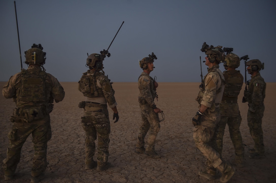 U.S. Air Force Special Tactics Airmen with the 23rd Special Tactics Squadron and Italy's 17th Stormo Incursori troops rally up after a high-altitude, low opening military free fall during Exercise Eager Lion May 16, 2017, in Jordan. Eager Lion 2017, an annual U.S. Central Command exercise in Jordan designed to strengthen military-to-military relationships between the U.S., Jordan and other international partners. This year's iteration is comprised of about 7,200 military personnel from more than 20 nations that will respond to scenarios involving border security, command and control, cyber defense and battlespace management. (U.S. Air Force photo by Senior Airman Ryan Conroy)