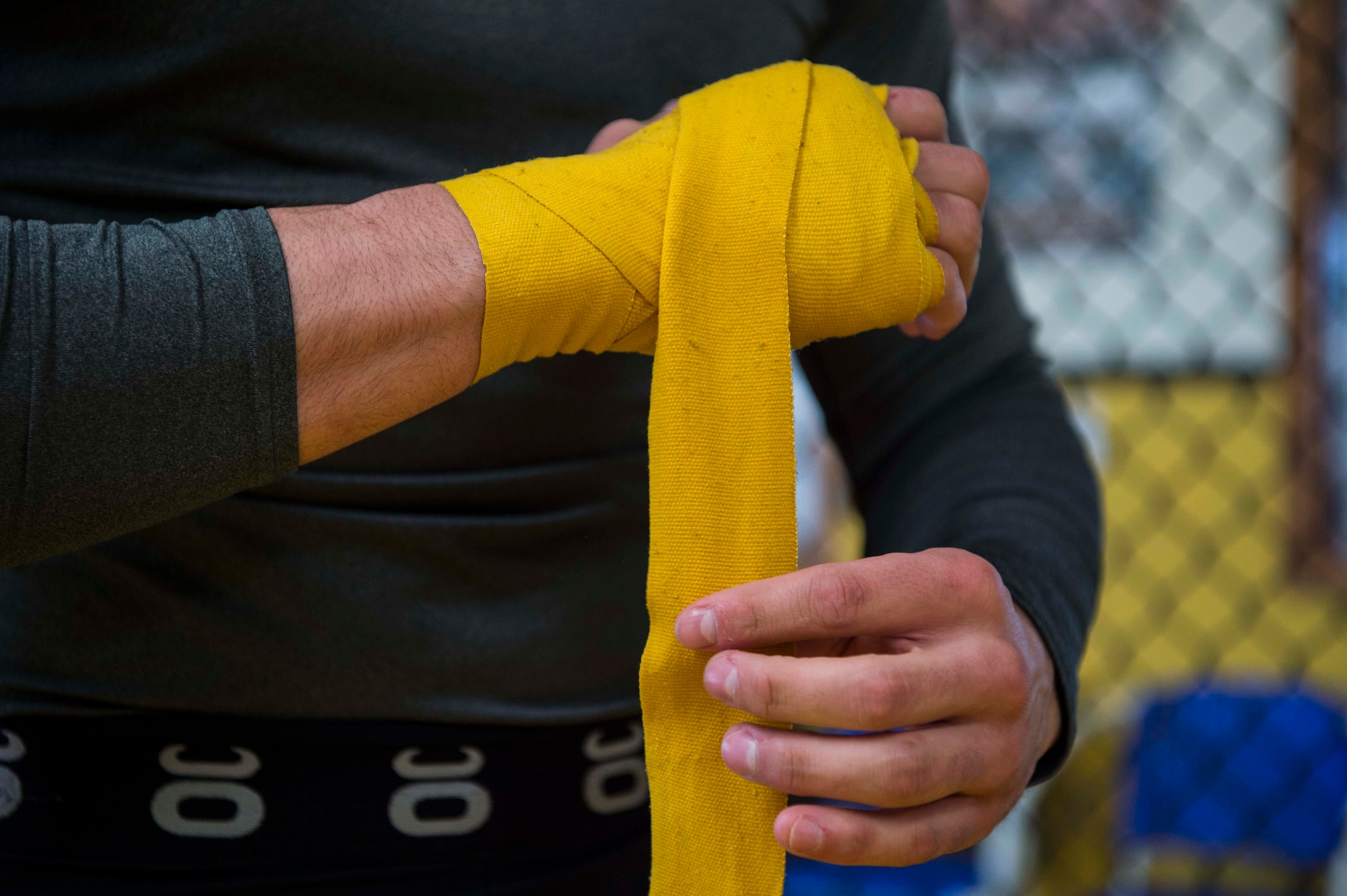 Airman 1st Class Raul Veliz, 90th Missile Security Forces Squadron response force leader, wraps his hands at Trials Mixed Martial Arts gym in Fort Collins, Colo., May 5, 2017. Veliz has a background in wrestling and recently started training for brazilian jiu jitsu and MMA. He is stationed at F.E. Warren Air Force Base, Wyo. (U.S. Air Force photo by Staff Sgt. Christopher Ruano)