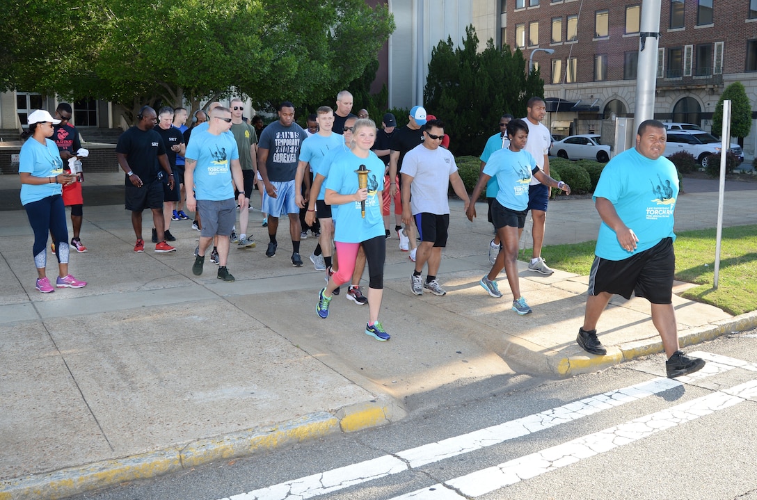 Marine Corps Logistics Base Albany police officers and active-duty service members represent the installation at Albany-Dougherty County’s annual 2017 Georgia Law Enforcement Torch Run for Special Olympics, May 16. Lt. Delaney Bourlakov, adjutant, MCLB Albany, carried the ceremonial torch and led the run with fellow-Marine comrades and Marine Corps Police Department personnel in the early morning kickoff and the 5k run, which followed. The day’s activities were held to commemorate the annual Law Enforcement Memorial Week, the Torch Run for Special Olympics and to honor fallen officers.