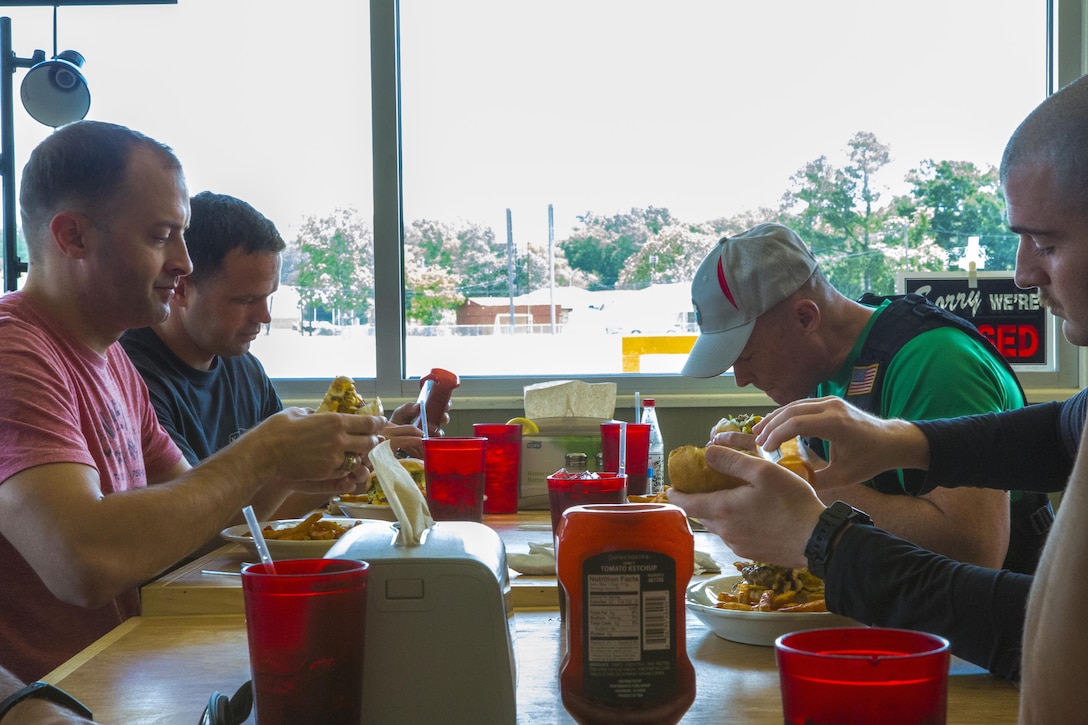 Marines with the Marine Corps Support Facility New Orleans Motorcycle Safety Mentorship Program eat at Swamp Bar and Grill in Thibodaux, Louisiana, May 17, 2017. The Marines made a stop to enjoy lunch as they share their experience as riders. (U.S. Marine Corps photo by Pfc. Melany Vasquez / Released)