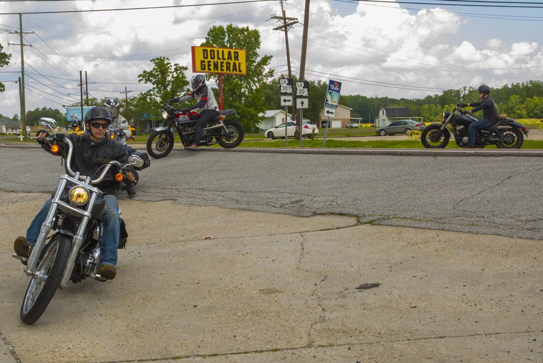 Marines with the Marine Corps Support Facility New Orleans Motorcycle Safety Mentorship Program ride into the parking lot at the Swamp Bar and Grill in Thibodaux, Louisiana, May 17, 2017. The Marine Corps Support Facility New Orleans Motorcycle Safety Mentorship Program, organized the 123 mile ride to teach Marines how to ride their motorcycle through various roads. (U.S. Marine Corps photo by Pfc. Melany Vasquez / Released)
