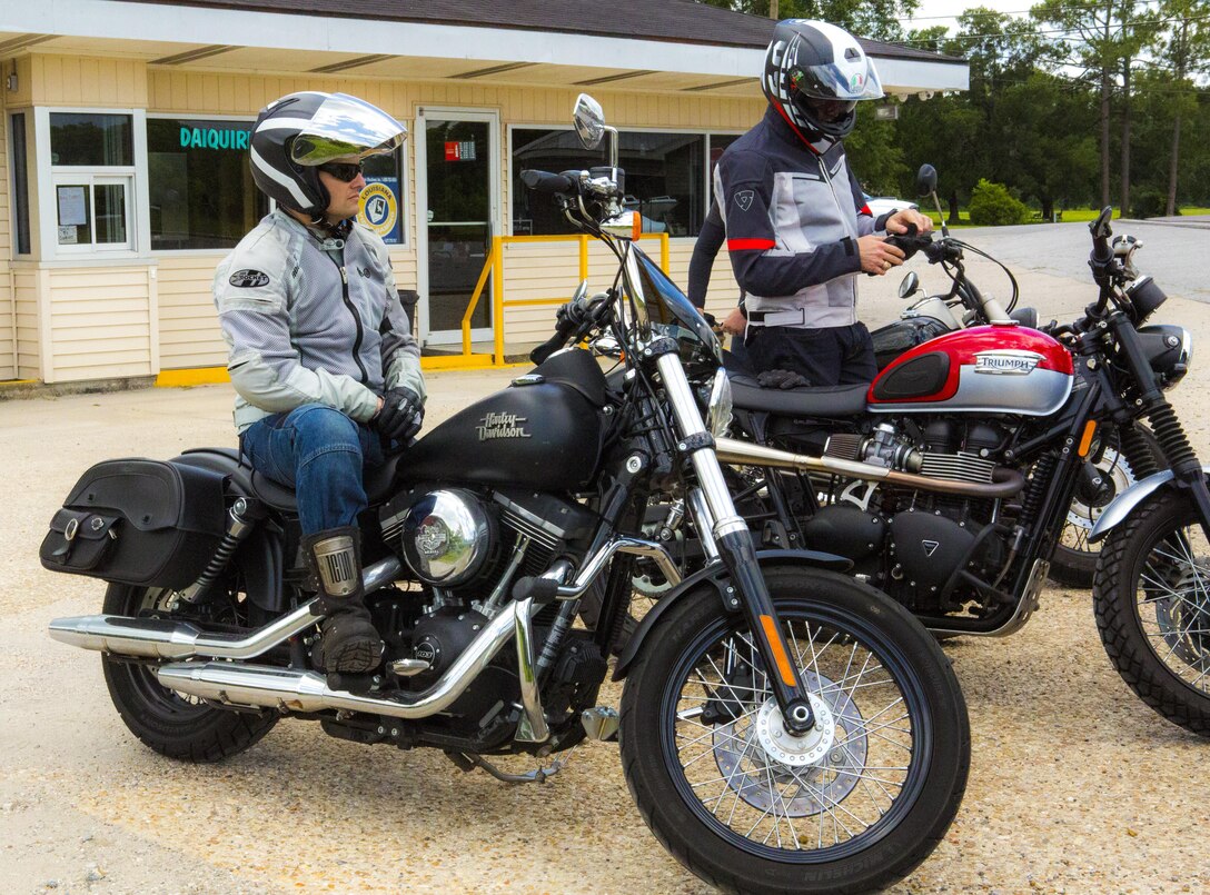 Maj. Andrew M. Aranda, a public affairs officer with Marine Forces Reserve, and Capt. Brad Pomy, the supply operations officer with MARFORRES, wait to depart with their fellow riders in Thibodaux, Louisiana, May 17, 2017. The Marine Corps Support Facility New Orleans Motorcycle Safety Mentorship Program, organized the 123 mile ride to teach Marines how to ride their motorcycle through various roads. (U.S. Marine Corps photo by Pfc. Melany Vasquez / Released)
