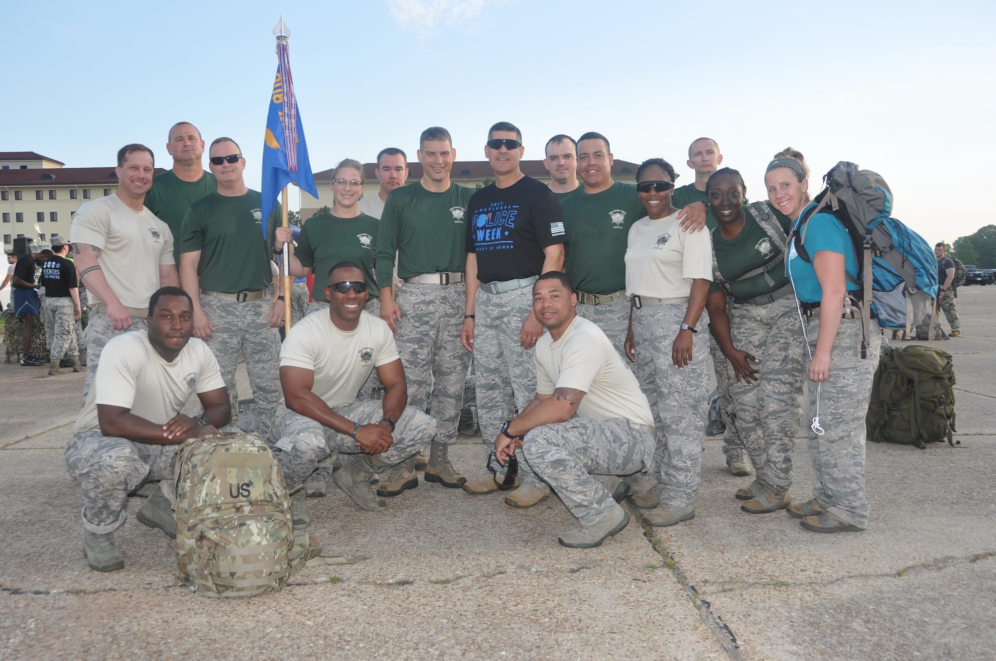 Members of the 908th Airlift Wing pose with Col. Ken Ostrat, 908th commander and Col. Eric Shafa, commander of the 42nd Air Base Wing, (center black shirt and sunglasses) prior to participating in the Commander’s Challenge 5K Ruck March at Maxwell Air Force Base, Ala., May 19. The event was in honor of National Police Week and sponsored by Shafa and his wing as the host unit at Maxwell Air Force Base. (U.S. Air Force photo by Bradley J. Clark)