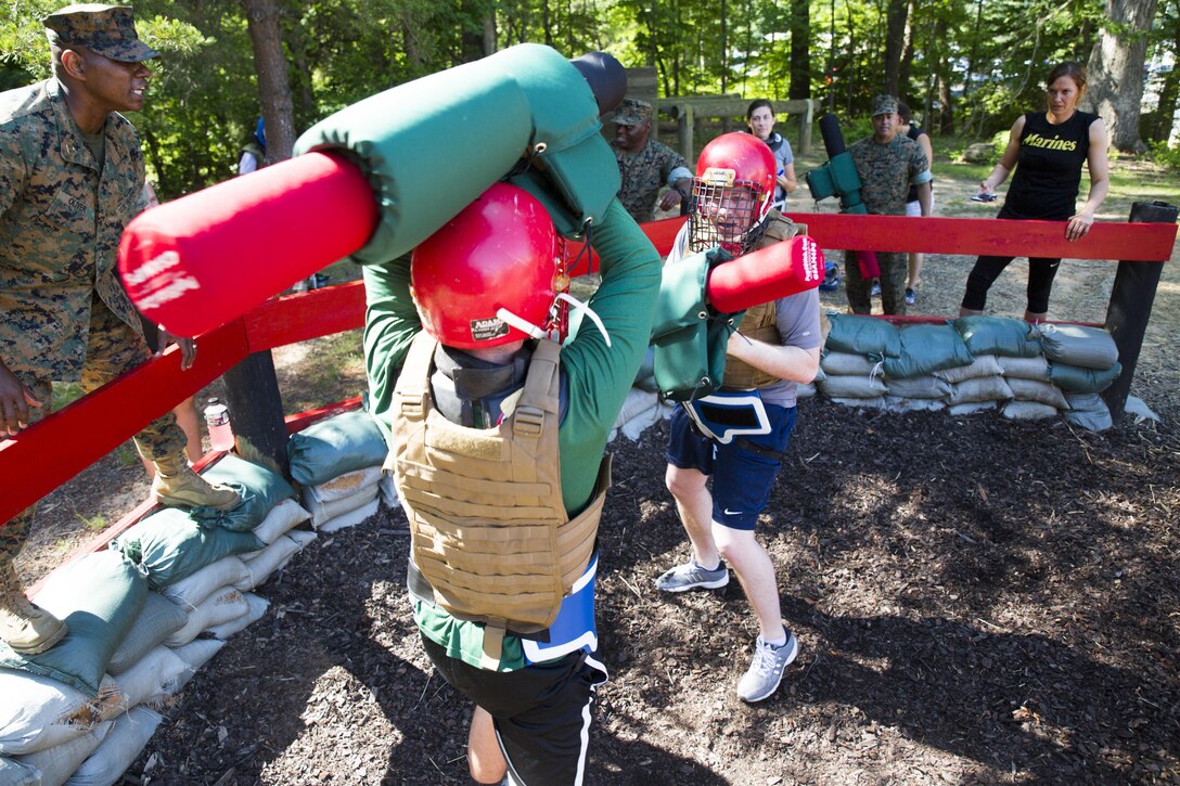 Matthew Armstrong (nearest) and Jacob Mattern pugil stick bout at the Force Fitness Readiness Center during the 2017 Coaches Workshop aboard Marine Corps Base Quantico, Va.,  May 19. The 35 coaches rotated between joint-manipulation techniques, basic strike techniques and pugil sticks. Throughout the workshop coaches will learn how to patrol, execute Marine Corps Martial Art techniques, learn about the Marine Corps’ officer programs and experience several different events. The workshop develops mutually beneficial relationships between collegiate influencers and the Marine Corps where coaches can share knowledge about the Marines to their athletes based on first-hand experiences. The FFRC was formally known as the Martial Arts Center of Excellence. Armstrong is the assistant women’s basketball coach for Point Loma Nazarene University, San Diego, Calif. Mattern is the head men’s volleyball coach for Graceland University, Lamoni, Iwoa.
