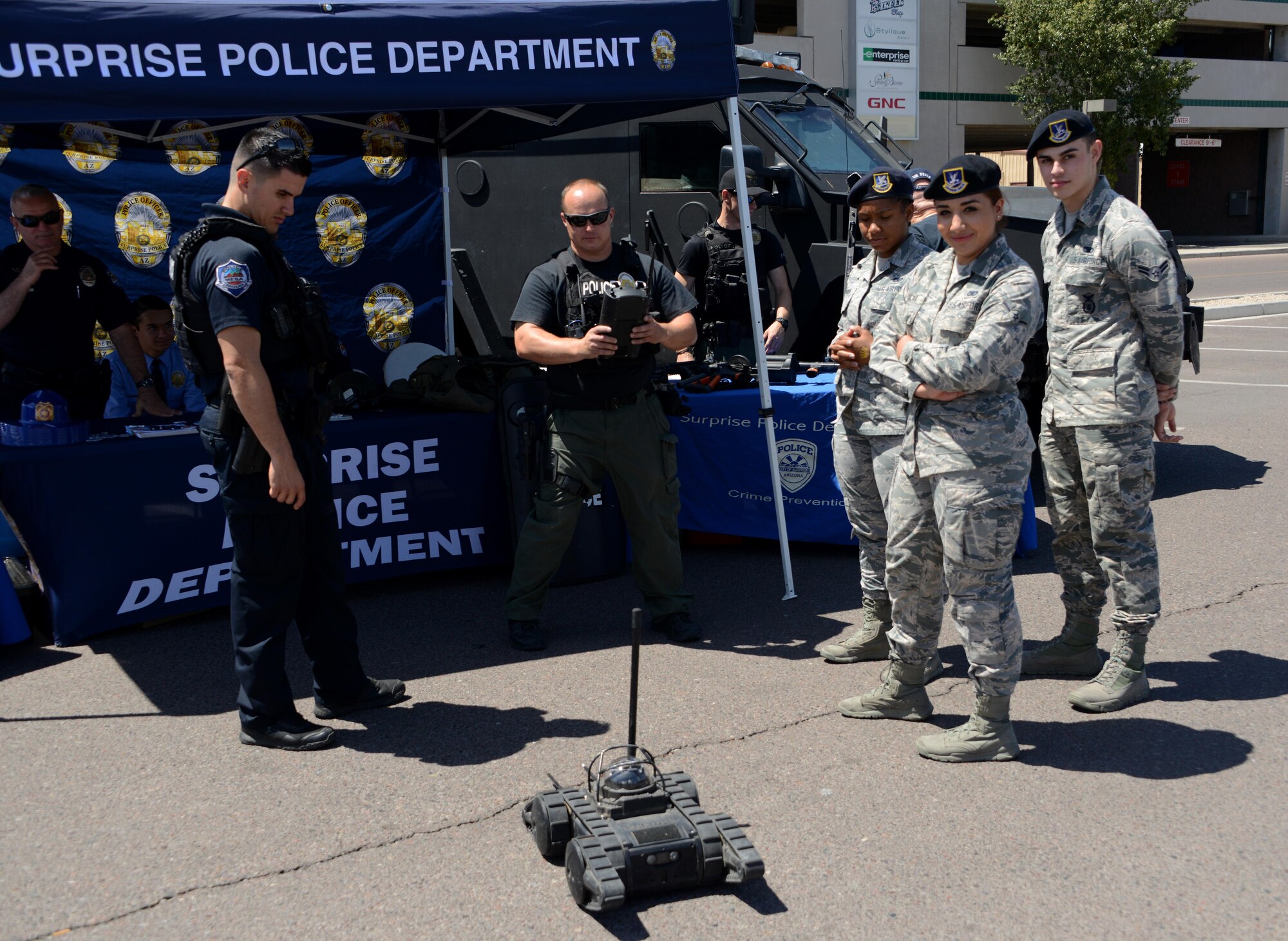 56th Security Forces Squadron Airmen interact with technology used by the Surprise Police Department May 15, 2017, at Luke Air Force Base, Ariz. A police awareness day was held in the commissary parking lot featuring the display of modern weapons used in ground combat, a face-painting tent and 56th SFS military working dogs. (U.S. Air Force photo by Airman 1st Class Alexander Cook)
