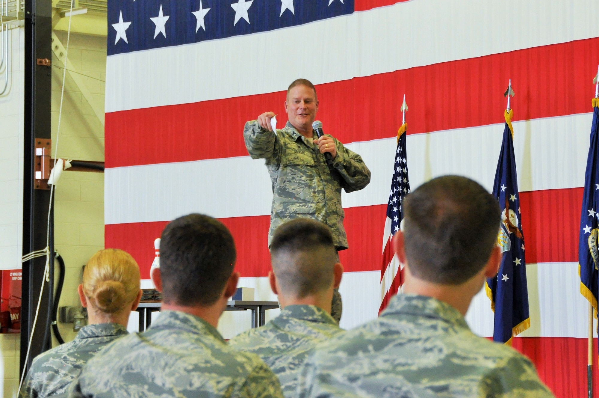 Col. James DeVere, the 302nd Airlift Wing commander, addresses an audience of more than 900 of the wing’s Reserve Citizen Airmen at a commander’s call held during the monthly Unit Training Assembly at Peterson Air Force Base, Colo., May 7, 2017. The commander’s call wrapped up with an interactive trivia game where representatives from each group answered questions related to information and practices of the 302nd AW. Afterward, Airmen were released to their respective squadrons to participate in the wing’s annual Wingman Day activities, which focused on resiliency and relationship building. (U.S. Air Force photo/Staff Sgt. Frank Casciotta)