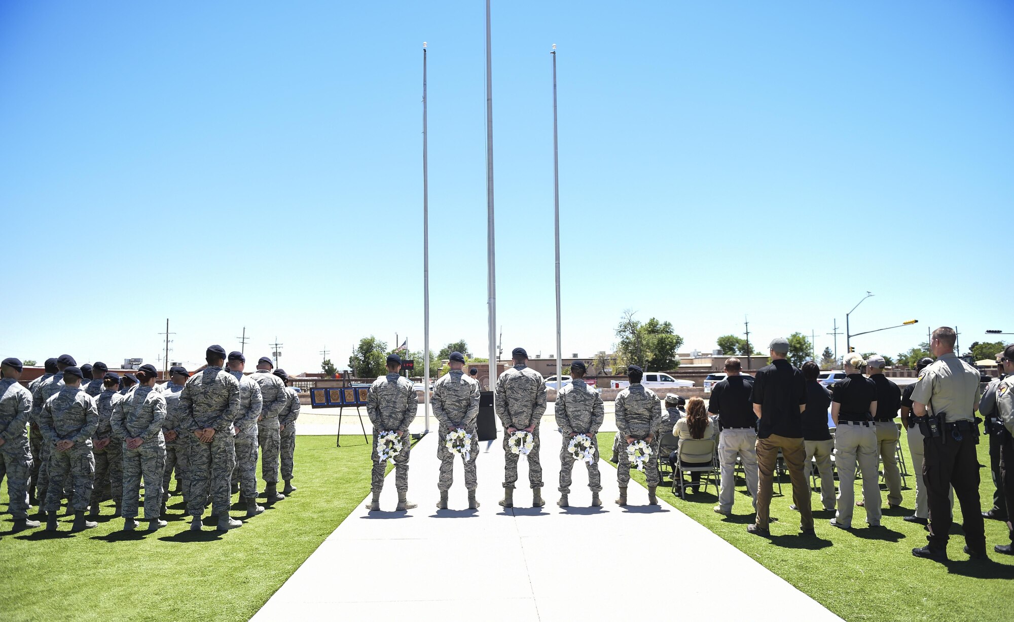 Members from local police departments and Airmen from Holloman Air Force Base Security Forces Squadron participate in a closing ceremony during National Police Week at Holloman Air Force Base, N.M. on May 15, 2017. National Police Week was established in 1962 by President John F. Kennedy to pay tribute to law enforcement officers who lost their lives in the line of duty for the safety and protection of others, according to the National Peace Officer's Memorial Fund website. Ceremonies are held annually in Washington D.C., as well as in communities across the nation. (U.S. Air Force photo by Staff Sgt. Stacy Jonsgaard)    