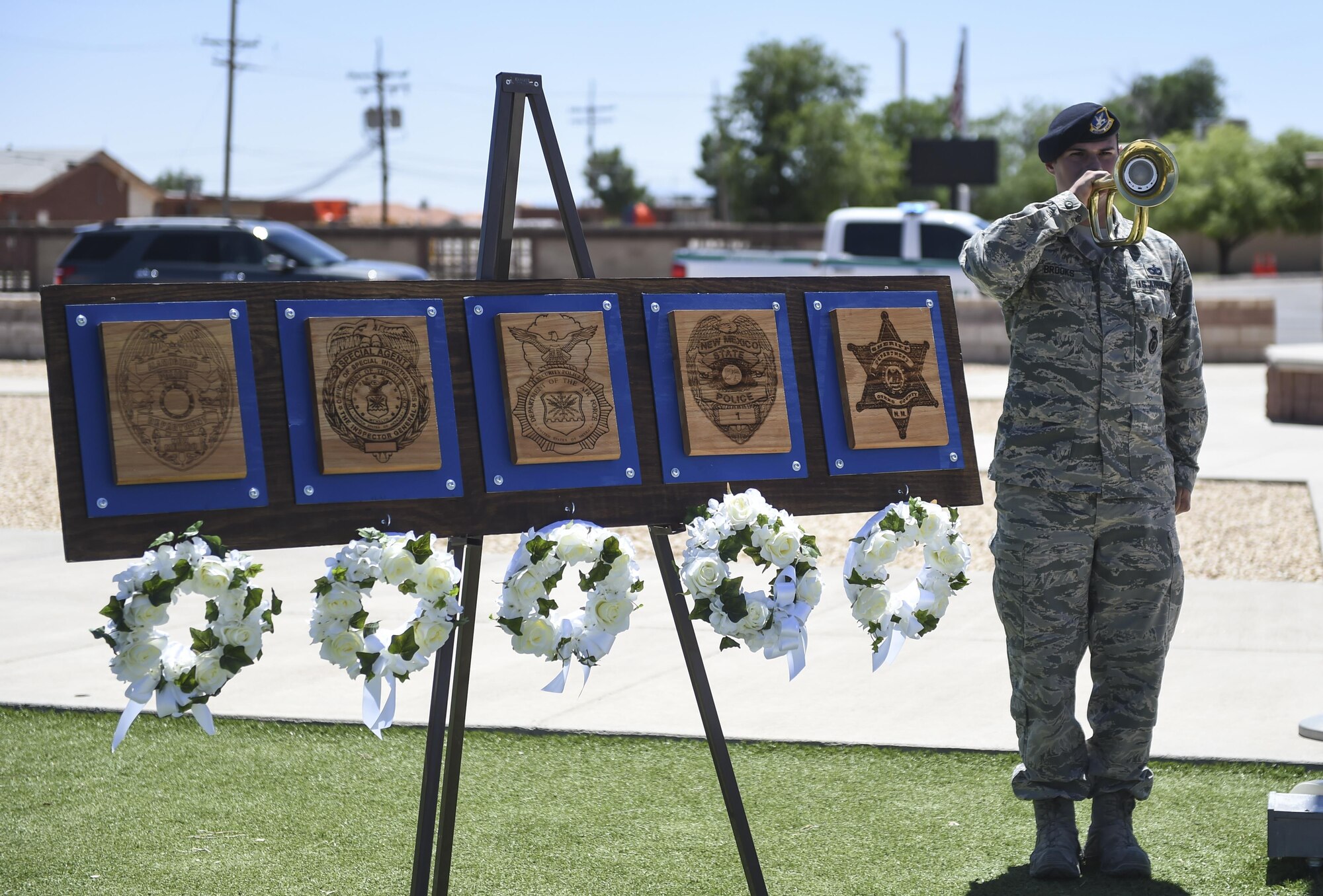 Staff Sgt. Caleb Brooks, 49th Security Forces Squadron, plays taps at the closing ceremony during National Police Week at Holloman Air Force Base, N.M. on May 15, 2017. National Police Week was established in 1962 by President John F. Kennedy to pay tribute to law enforcement officers who lost their lives in the line of duty for the safety and protection of others, according to the National Peace Officer's Memorial Fund website. Ceremonies are held annually in Washington D.C., as well as in communities across the nation. (U.S. Air Force photo by Staff Sgt. Stacy Jonsgaard)    