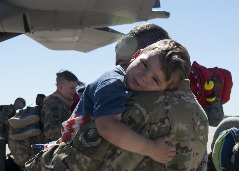 U.S. Air Force Capt. Geoffrey Britzke, 39th Airlift Squadron C-130J Super Hercules pilot, embraces his son after a four-month deployment to Afghanistan at Dyess Air Force Base, Texas, May 17, 2017. Family and friends expressed their excitement and eagerness by holding up signs and exchanging hugs and kisses once their loved ones landed and exited the planes. (U.S Air Force photo by Airman 1st Class Katherine Miller)