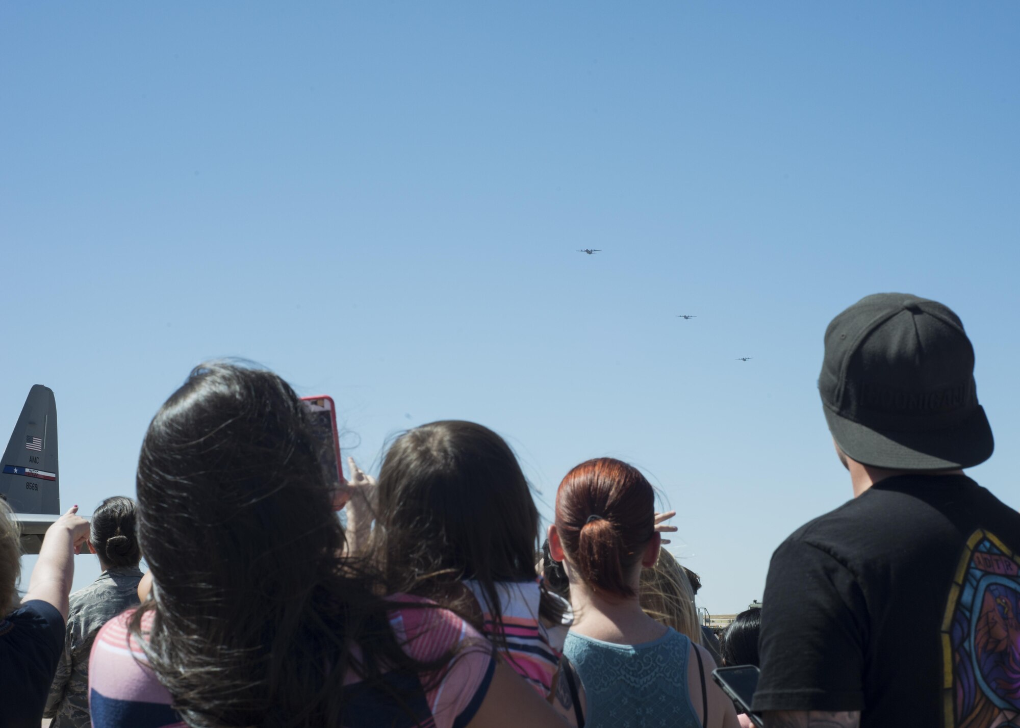 Family and friends of Airmen of the 39th Airlift Squadron anticipate the return of their loved ones at Dyess Air Force Base, Texas, May 17, 2017. The aircrew were deployed to Afghanistan for a four-month deployment rotation and accomplished multiple missions to support their area of responsibility. (U.S. Air Force photo by Airman 1st Class Katherine Miller)