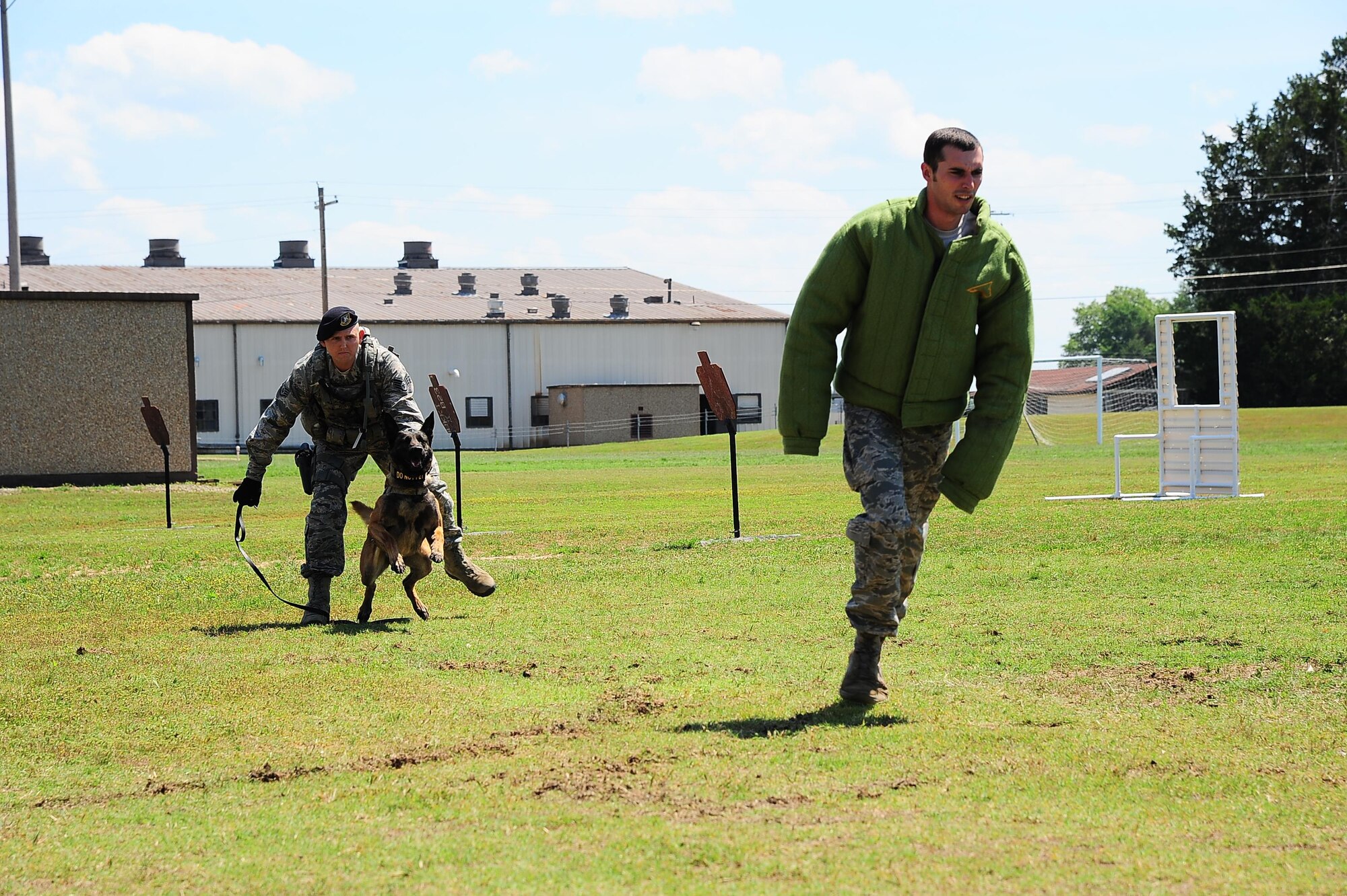 Staff Sgt. Derek Mortensen, 14th Security Forces Squadron Military Working Dog Handler, releases MWD Dito to attack a perpetrator, Senior Airman Zachary Kunkler, 14th SFS MWD Handler, during a demonstration May 16, 2017, at Columbus Air Force Base, Mississippi. The demonstration was in honor of Police Week and raising awareness for the many different jobs that Defenders do in order to keep Air Force bases and assets safe. (U.S. Air Force photo by Airman 1st Class Beaux Hebert)