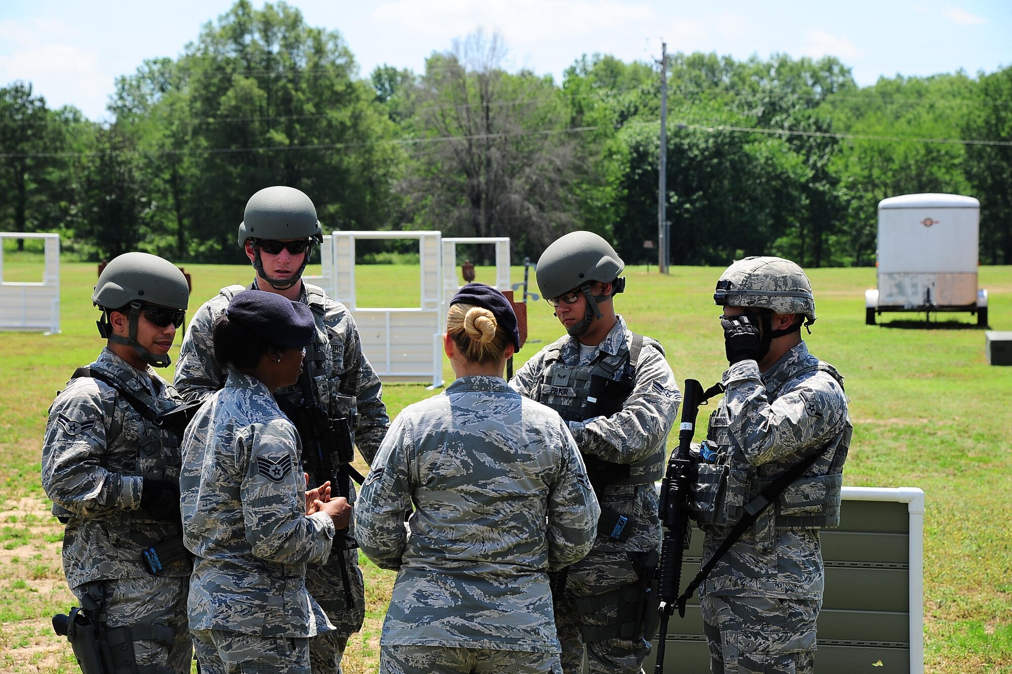 Staff Sgt. Ashley Maury and Airman 1st Class Sarah Sillitoe discuss the Shoot, Move, Communicate drill May 16, 2017, at Columbus Air Force Base, Mississippi. Defenders do this drill at least once a year to maintain weapon proficiency and tactics. (U.S. Air Force photo by Airman 1st Class Beaux Hebert)