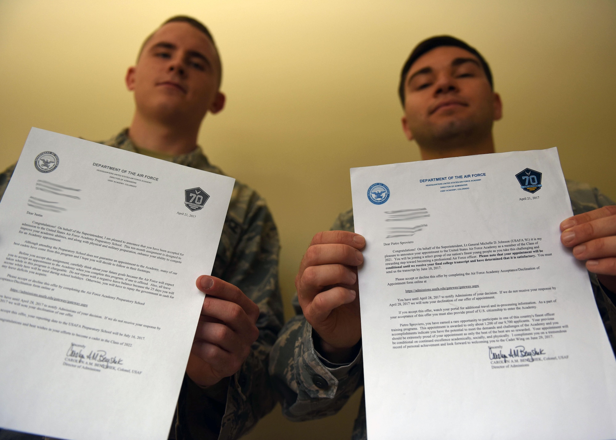 Senior Airman Justin Wilmoth, 30th Security Forces Squadron response force leader, and Airman 1st Class Pietro Sproviero De Paoli, 30th SFS armory technician, hold their Air Force Academy and Preparatory School acceptance letters, May 17, 2017, Vandenberg Air Force Base, Calif. Since its inception in 1954, the United States Air Force Academy has been considered one of the nation's most prestigious and selective universities. (U.S. Air Force photo by Senior Airman Kyla Gifford/Released)