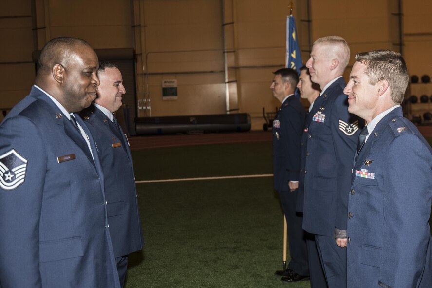 Master Sgt. Carl White 3rd Space Operations Squadron first sergeant, and Lt. Col. Joshua Brooks, 3 SOPS commander, conduct a final uniform inspection of the squadron in preparation for the standing down and integration into the 4th Space Operations Squadron at Schriever Air Force Base, Colorado, Friday, May 12, 2017. The squadrons will be formally merged June 13, 2017. (U.S. Air Force photo/Staff Sgt. Christopher Moore)