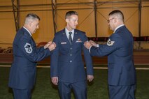 Senior Master Sgt. Patrick Kincaid, 4th Space Operations Squadron superintendent, and Tech. Sgt. William Farrington (right), 3 SOPS training flight chief, recognize Senior Airman Justin Yeager (center), 3rd Space Operations Squadron Wideband Global Satellite Communications satellite vehicle operator, for completing Airman Leadership School and promoting to staff sergeant during the last uniform inspection of 3 SOPS at Schriever Air Force Base, Colorado, Friday, May 12, 2017. 3 SOPS activated at Schriever Air Force base in 1990 and will be officially absorbed into 4 SOPS in June. (U.S. Air Force photo/Staff Sgt. Christopher Moore)