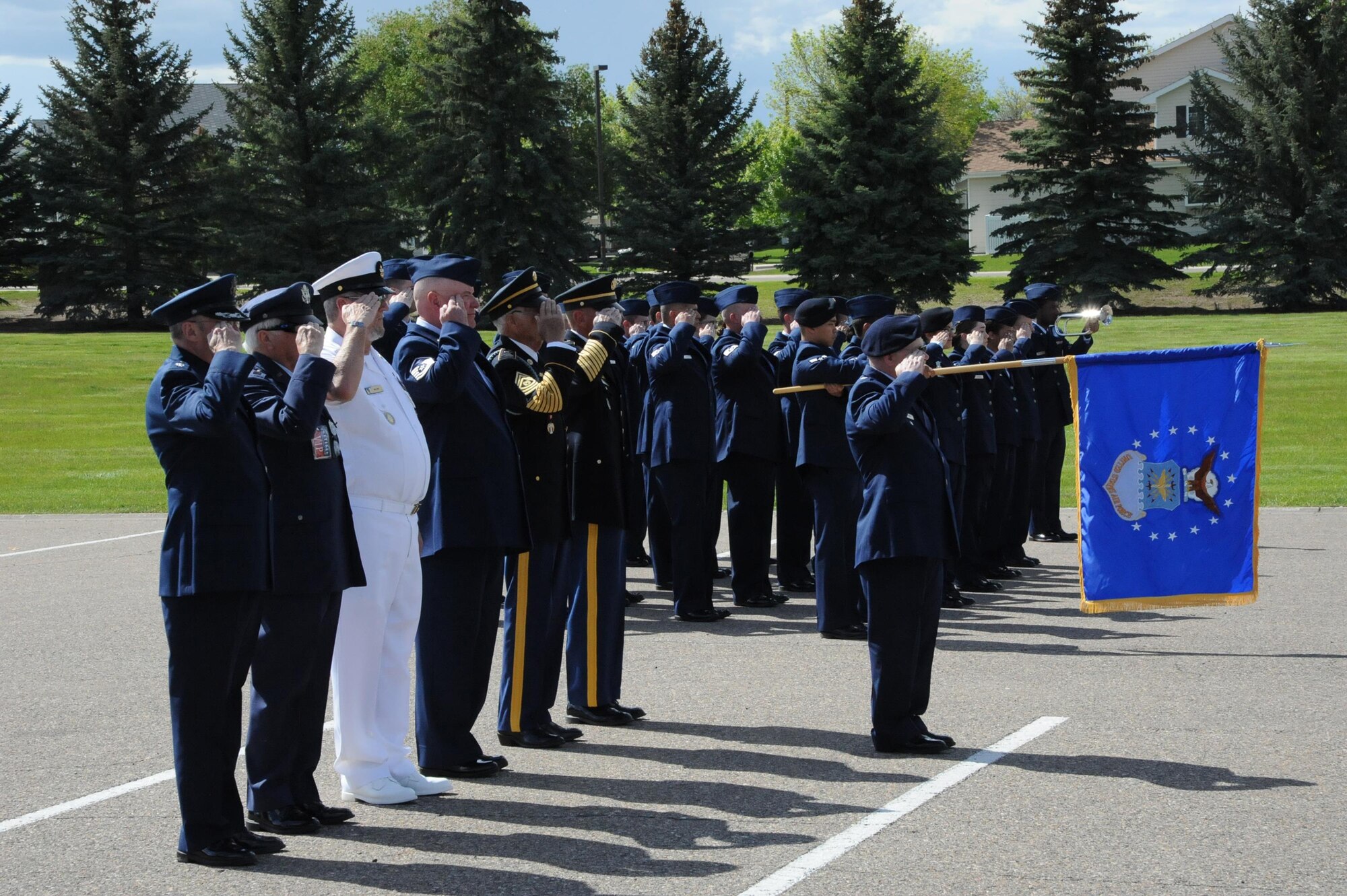 Active-duty Airmen and retired military members salute while taps is played during a retiree appreciation retreat ceremony at Medal of Honor Park at Malmstrom Air Force Base, Mont. The event was part of the wing’s annual retiree appreciation day held May 19, 2017. (U.S. Air Force photo/Christy Mason)
