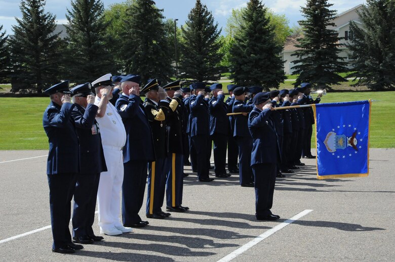 Active-duty Airmen and retired military members salute while taps is played during a retiree appreciation retreat ceremony at Medal of Honor Park at Malmstrom Air Force Base, Mont. The event was part of the wing’s annual retiree appreciation day held May 19, 2017. (U.S. Air Force photo/Christy Mason)