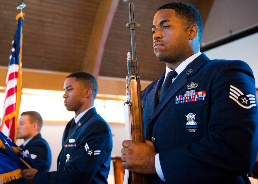 96th Security Forces Squadron Airmen perform the flag detail during the National Police Week candlelight vigil May 18 at Eglin Air Force Base, Fla. The ceremony was held to honor the police, defenders and the agents who paid the ultimate sacrifice in the line of duty.  To remember them, 14 candles were lit. (U.S. Air Force photo/Ilka Cole)