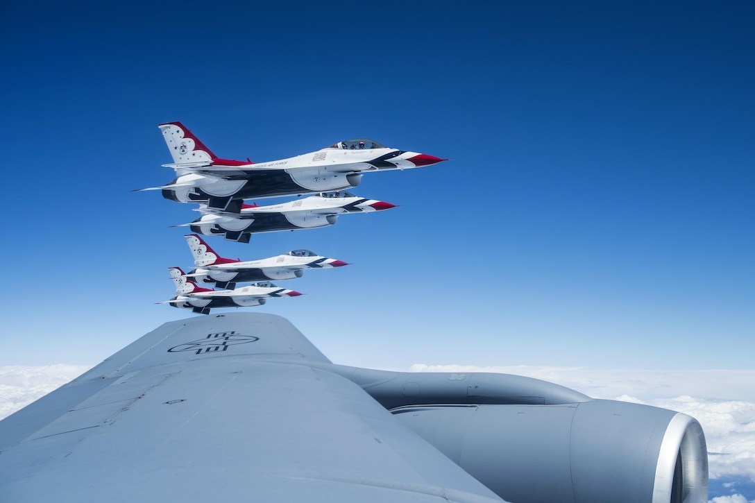 Four F-16 Fighting Falcons assigned to the Thunderbirds, the Air Force’s air demonstration squadron, fly off the wing of a KC-135 Stratotanker before conducting an aerial refueling en route to Tinker Air Force Base, Okla., May 18, 2017. The Thunderbirds will headline Tinker's Star Spangled Salute Air Show. Air Force photo by 2nd Lt. Caleb Wanzer