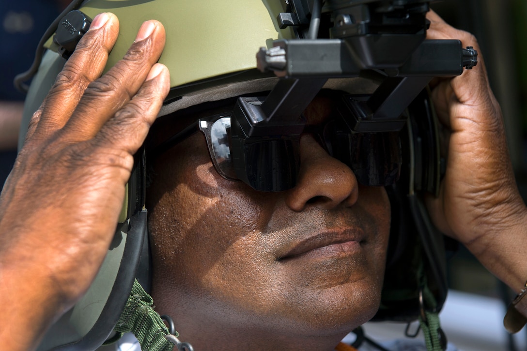 Aryankalayil Babu tries an Army aviation helmet with heads up display during the DoD Lab Day at the Pentagon, May 18, 2017. DoD photo by EJ Hersom