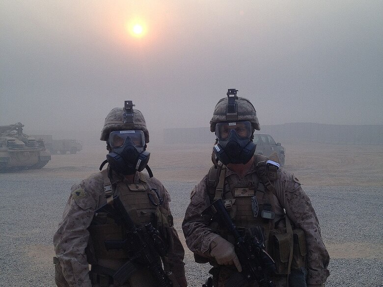 Cpl. Ali J. Mohammed, a translator with the Advise and Assist Team from the Special Purpose Marine Air-Ground Task Force-Crisis Response-Central Command, and Maj. Ryan Hunt, the officer in charge of the A&A Team from the SPMAGTF-CR-CC, pose for a photo at Qayyarah Airfield West, Iraq, Oct. 25, 2016. The Marines of the A&A Team were able to overcome these conditions and continue operating due to their CBRN training. U.S. Marines receive this training throughout their careers and before deploying in order to effectively respond to an attack and continue accomplishing the mission.