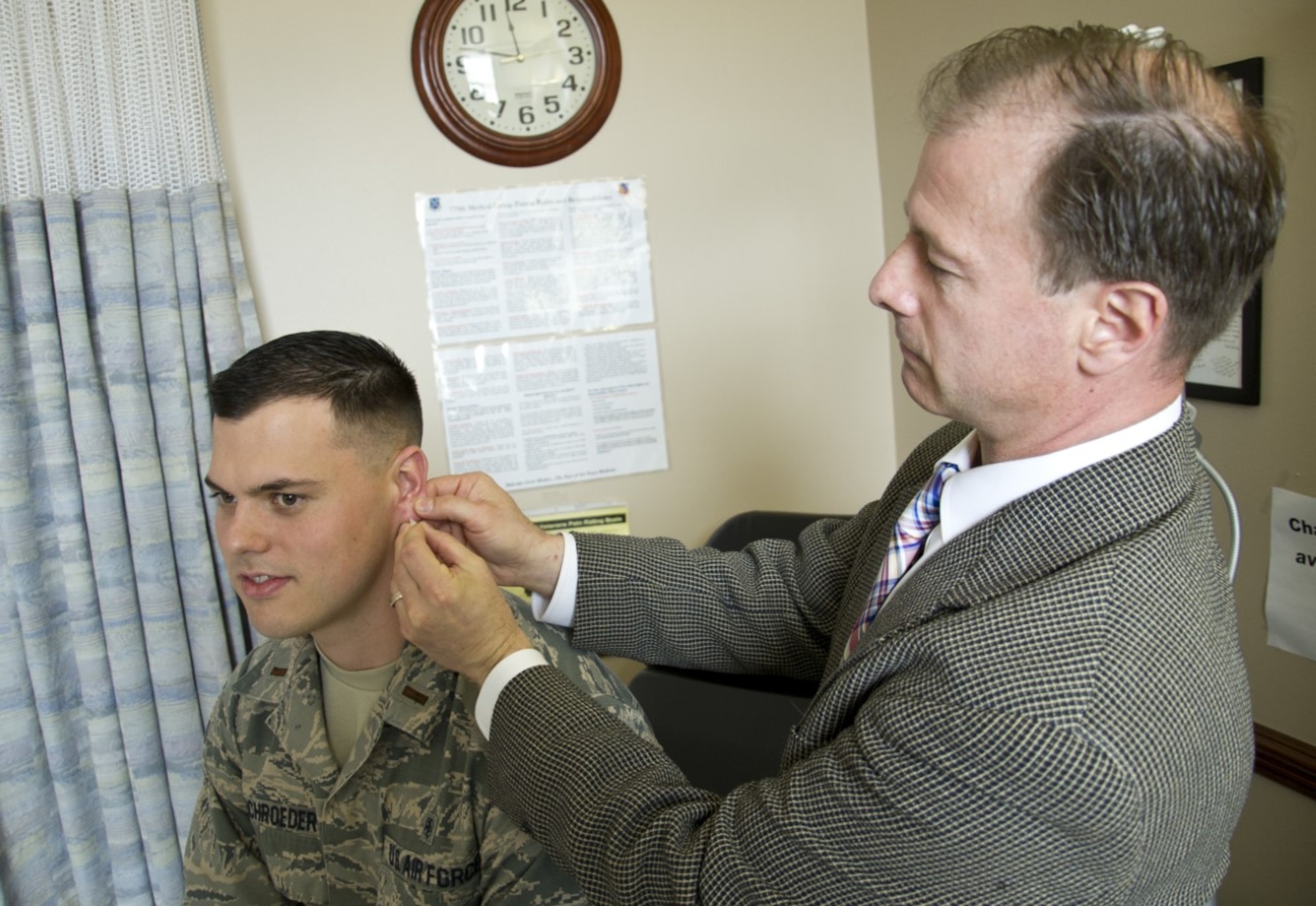 Dr. Thomas Piazza (right), U.S. Air Force Acupuncture Program director with the 779th Medical Group, inserts a semi-permanent acupuncture needle, or ASP, into the ear of 2nd Lt. Paul Schroeder, a Uniformed Services University student working with Dr. Piazza March 28, 2017, at Joint Base Andrews, Md. Piazza works with others at the Air Force Acupuncture and Integrative Medicine Clinic, the Department of Defense’s only acupuncture therapy facility with a full time, licensed acupuncture staff of physicians. (U.S. Air Force photo by Staff Sgt. Joe Yanik)