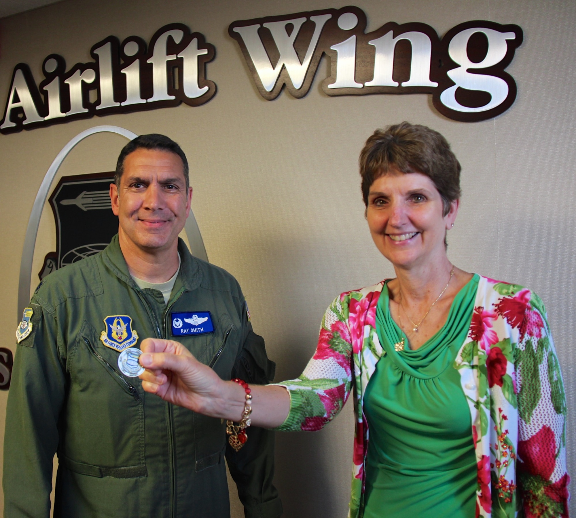 Commander of the 932nd Operations Group at the 932nd Airlift Wing, Lt. Col. Ray Smith, presents Lt. Col. Stephanie Boehning with a special coin recognizing her military years of service to the unit and the nation.  She enjoyed the surprise retirement party put on by her fellow wing staff members on May 18, 2017 at Scott Air Force Base, Illinois.  Boehning served with honor during Desert Storm overseas, and a variety of jobs with the 932nd Airlift Wing.  She will now will continue working as the wing's civilian process improvement manager and certified Covey facilitator.  (U.S. Air Force photo by Lt. Col. Stan Paregien)