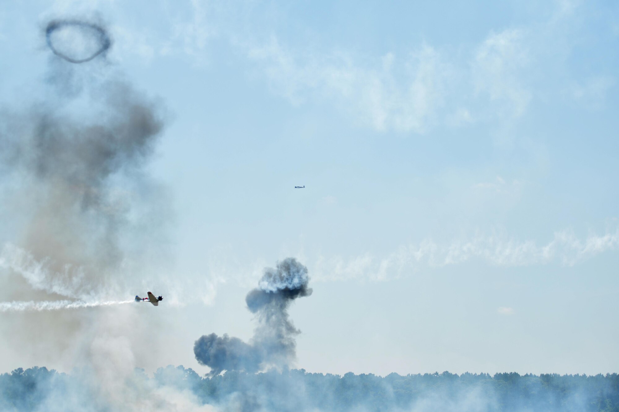 World War II-era Japanese and American aircraft fly as part of the "Tora! Tora! Tora!" performance during Wings Over Wayne Air Show, May 20, 2017, at Seymour Johnson Air Force Base, North Carolina. The performance is a re-creation of the Japanese attack on Pearl Harbor and is intended to memorialize all the service members who lost their lives on that day. (U.S. Air Force photo by Airman 1st Class Christopher Maldonado)