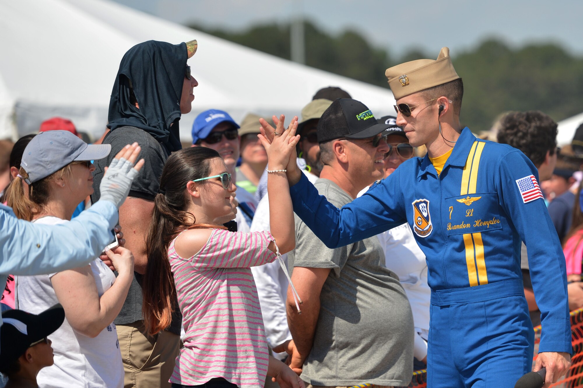 Spectators interact with a U.S. Navy Blue Angels member during the Wings Over Wayne Air Show, May 20, 2017, at Seymour Johnson Air Force Base, North Carolina. The Blue Angels have performed for more than 500 million fans since 1946. (U.S. Air Force photo by Airman 1st Class Christopher Maldonado)